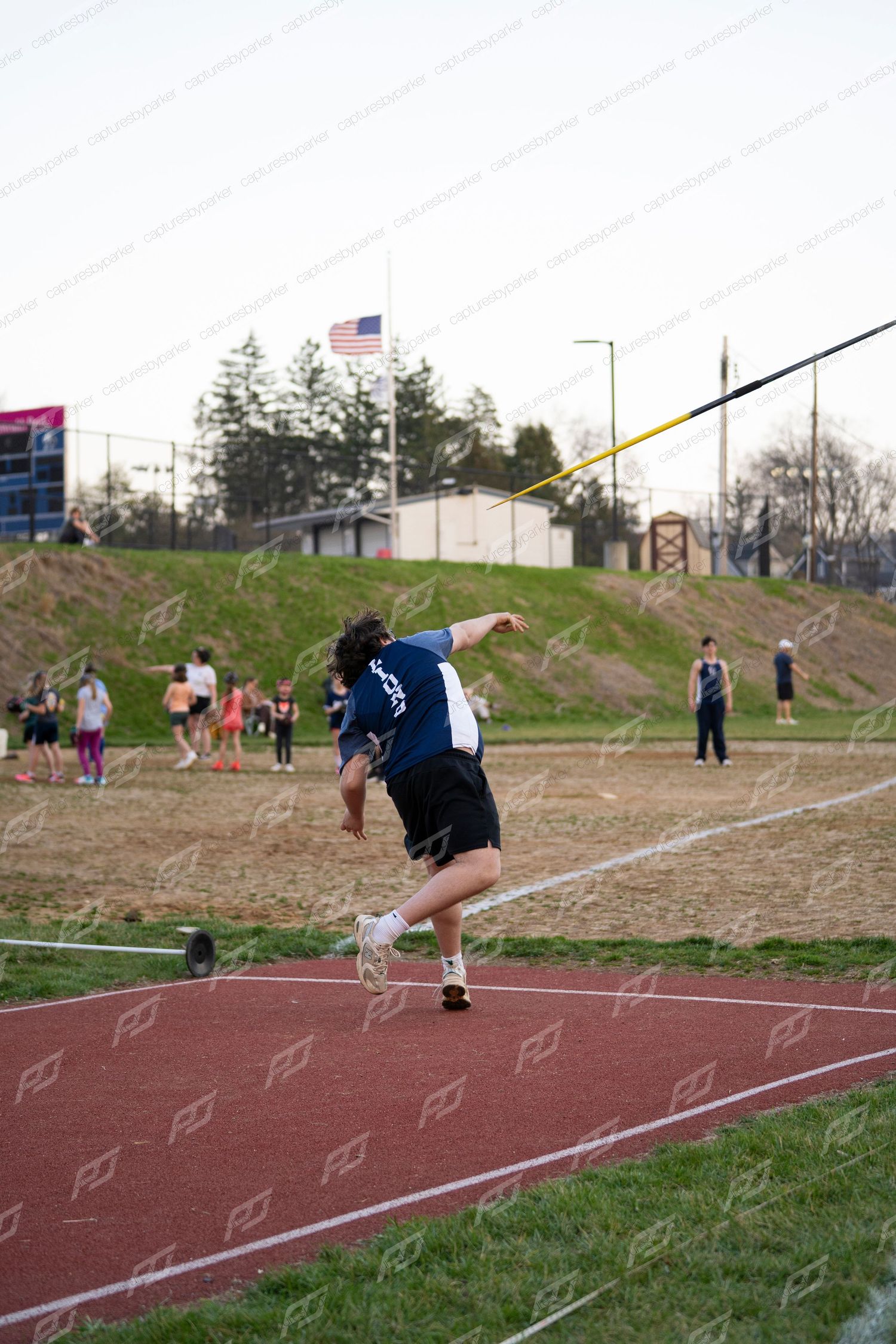 Male Lions athlete in follow-through position after javelin throw.