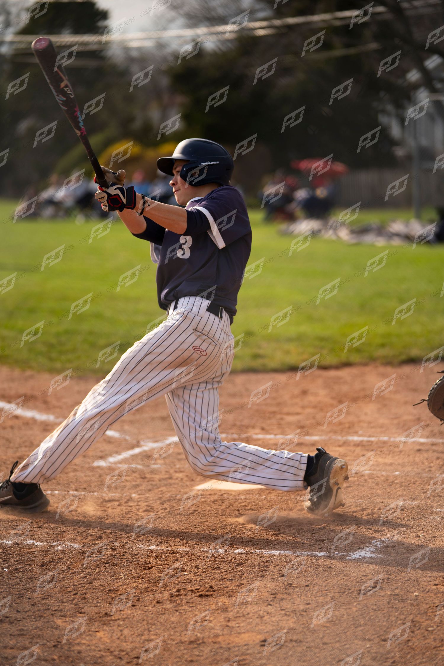 Baseball player #3 in navy pinstripe uniform making contact during an at-bat.