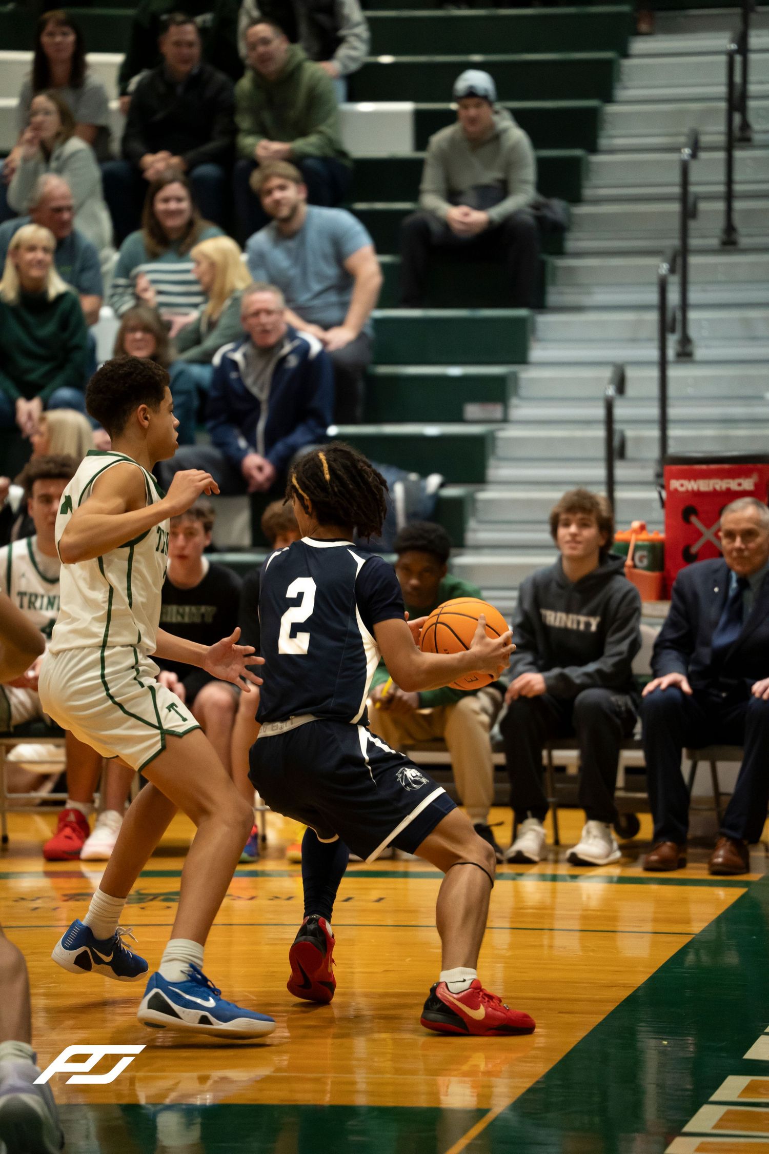 Camp Hill Lions number 2 handles the ball along the baseline during a high school game.
