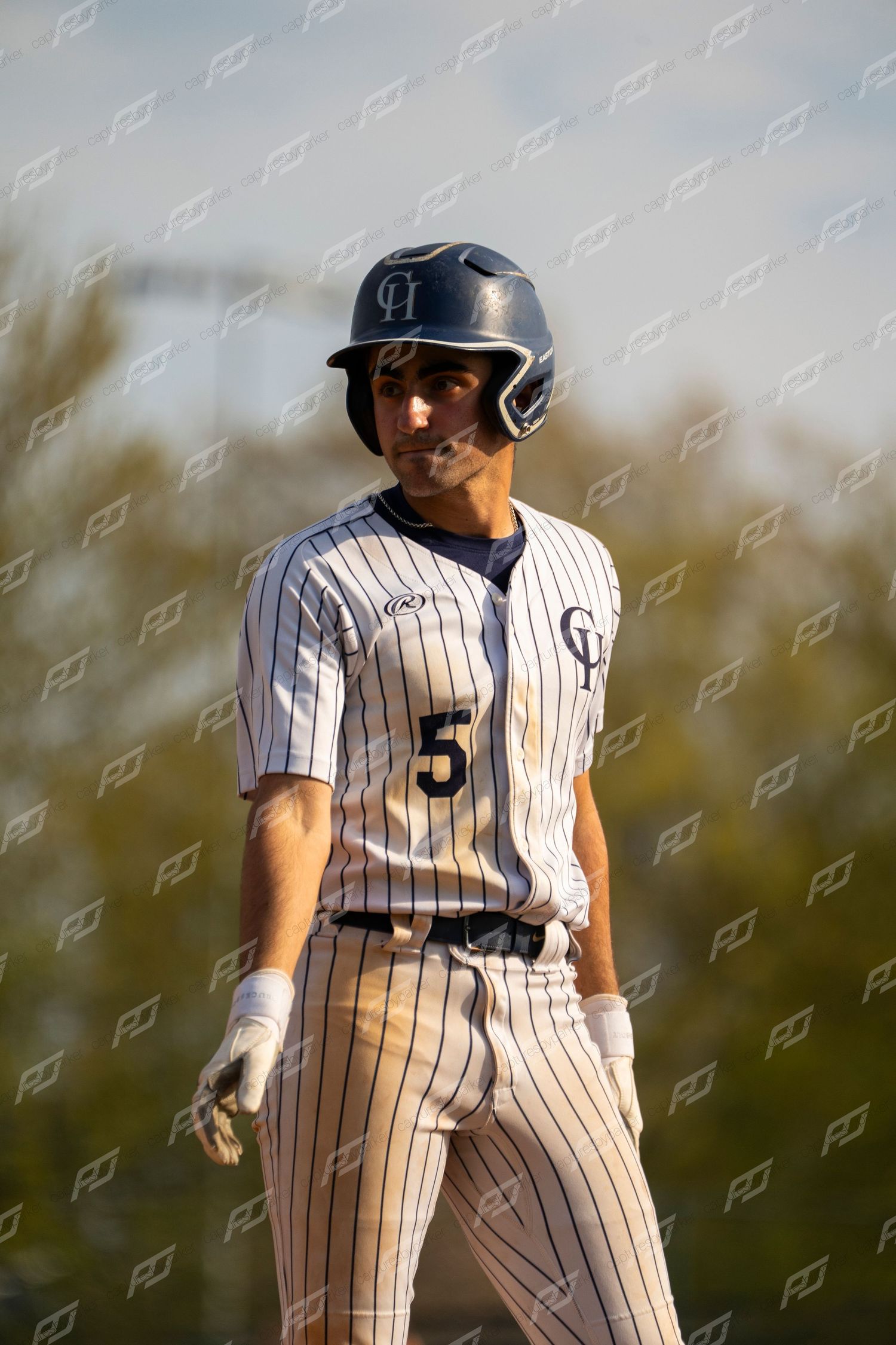 Baseball player number 5 in pinstripe uniform standing confidently on the base path.