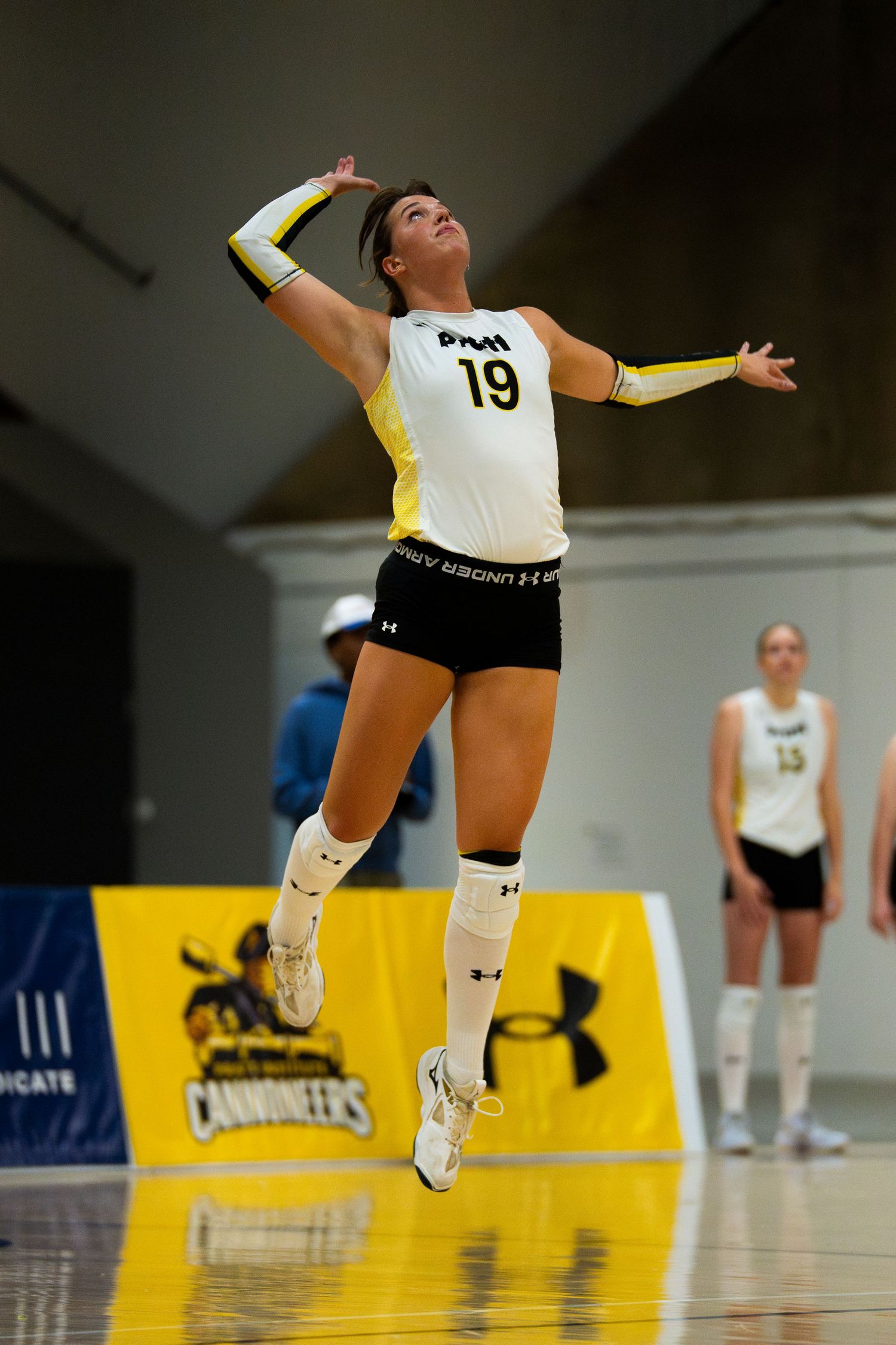 PFW Cannoneers volleyball player number 19 jumps to serve during a home match at Purdue Fort Wayne.