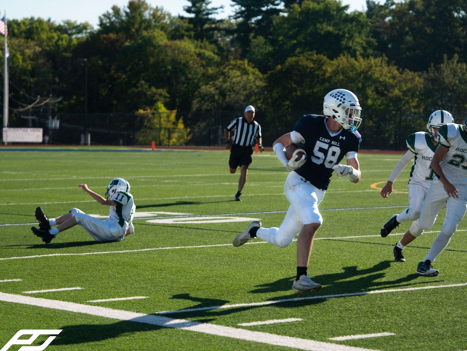 Camp Hill youth football player number 58 breaks away for a long run during a game.