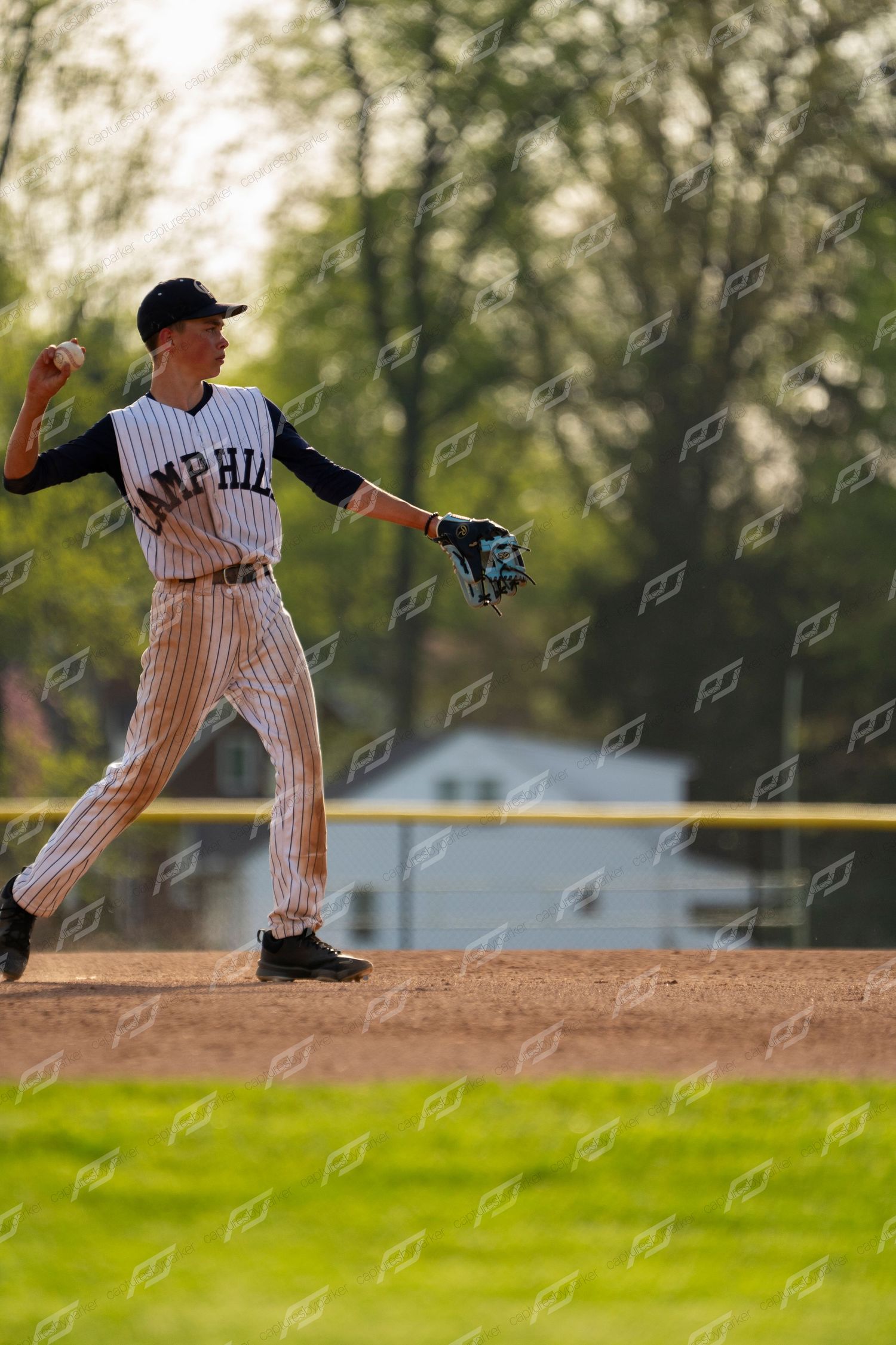 Camp Hill baseball infielder throws across the diamond during a game.