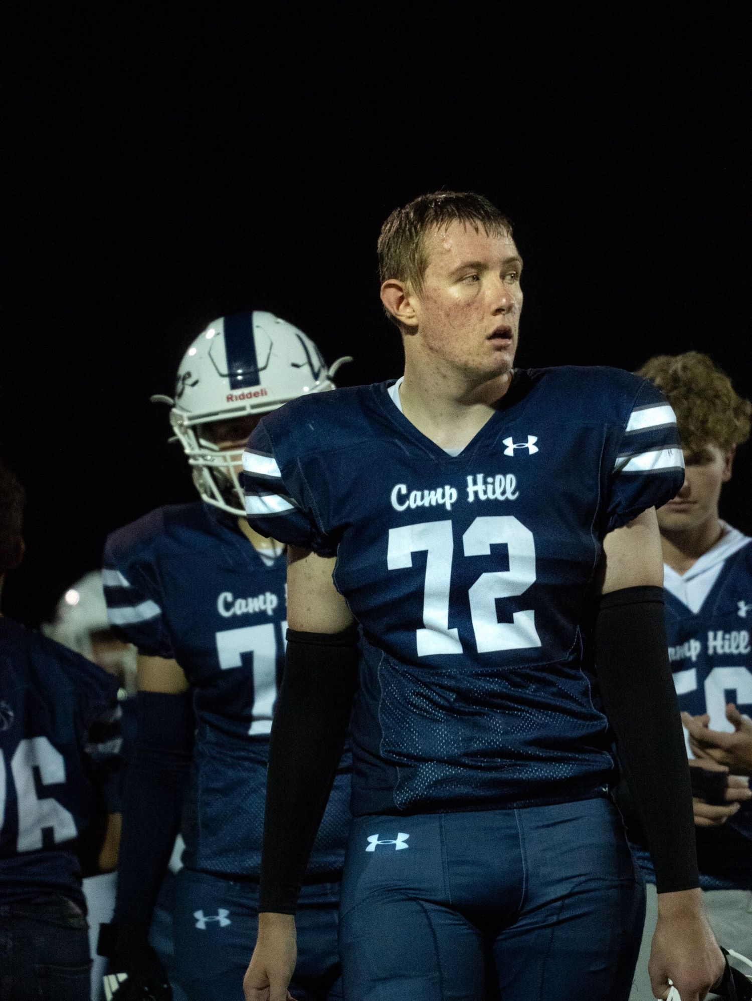 Camp Hill Lions football player number 72 in navy Under Armour jersey during a night game.