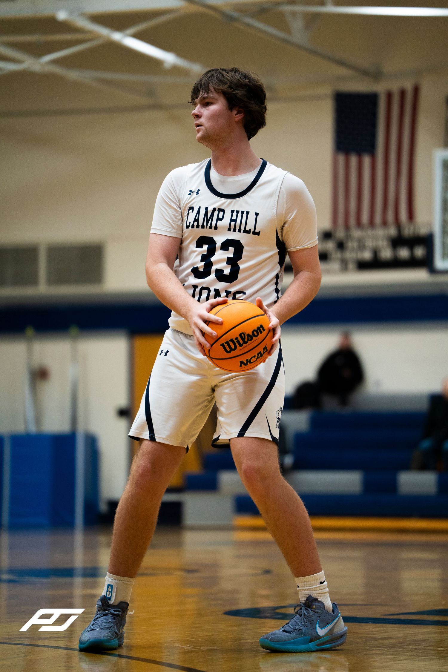 Camp Hill Lions #33 prepares to shoot a free throw during a home basketball game.
