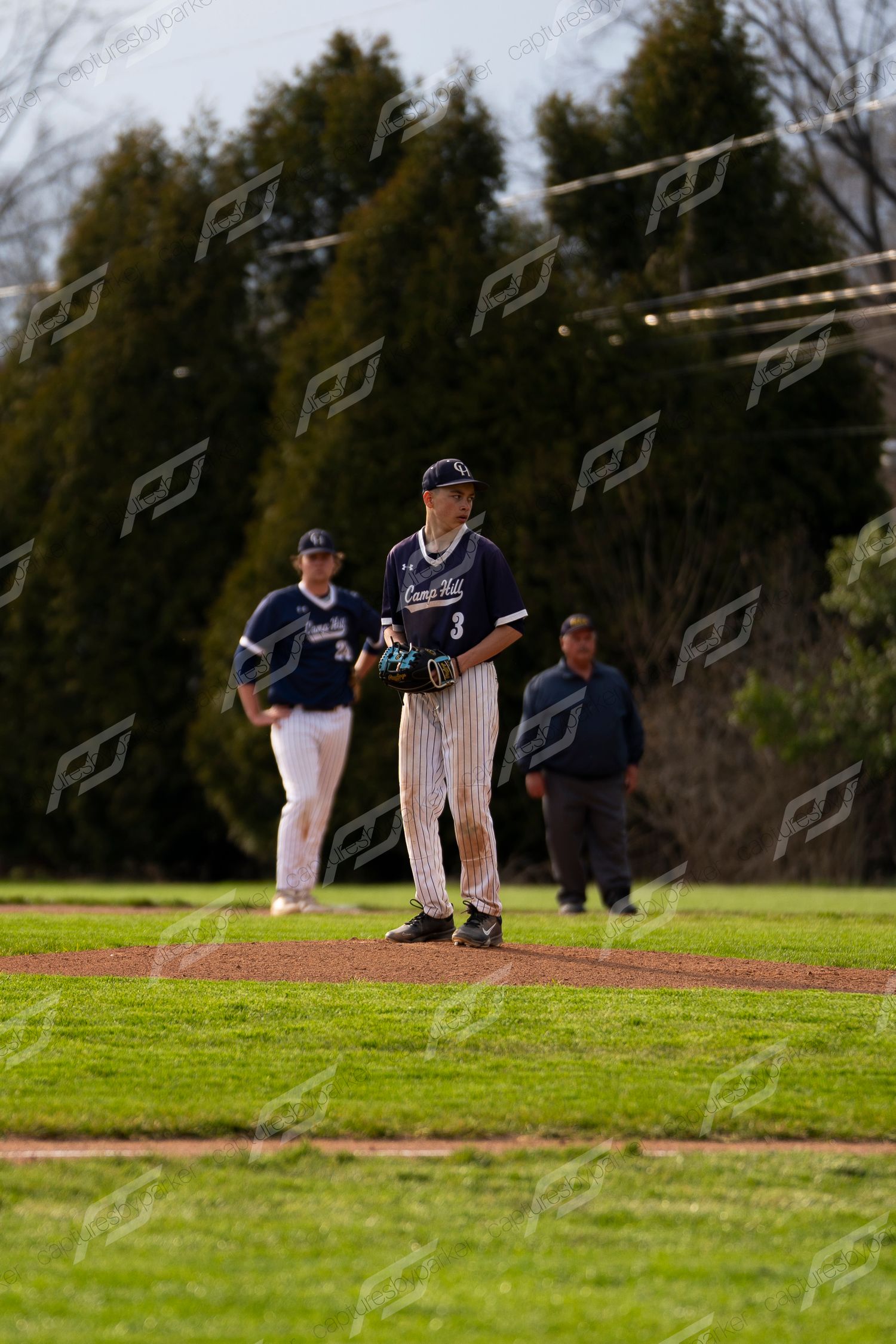 Baseball pitcher #3 in navy pinstripe uniform stands on mound ready to pitch.