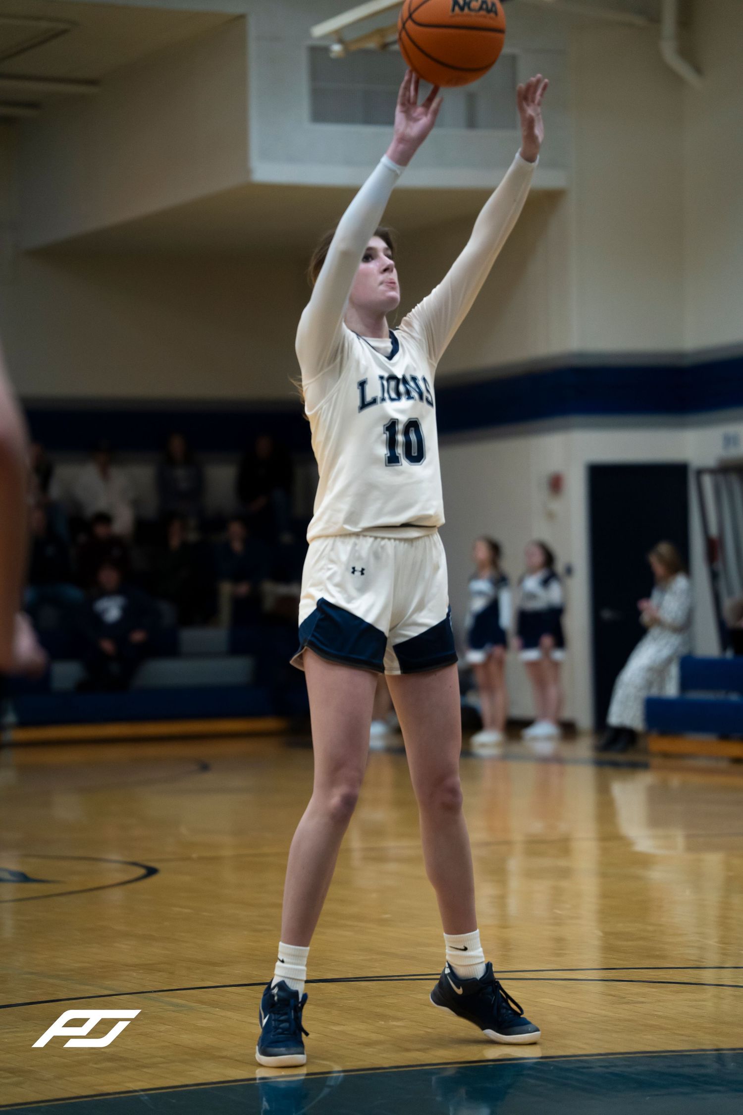 Lions number 10 shoots a free throw during a girls high school basketball game.