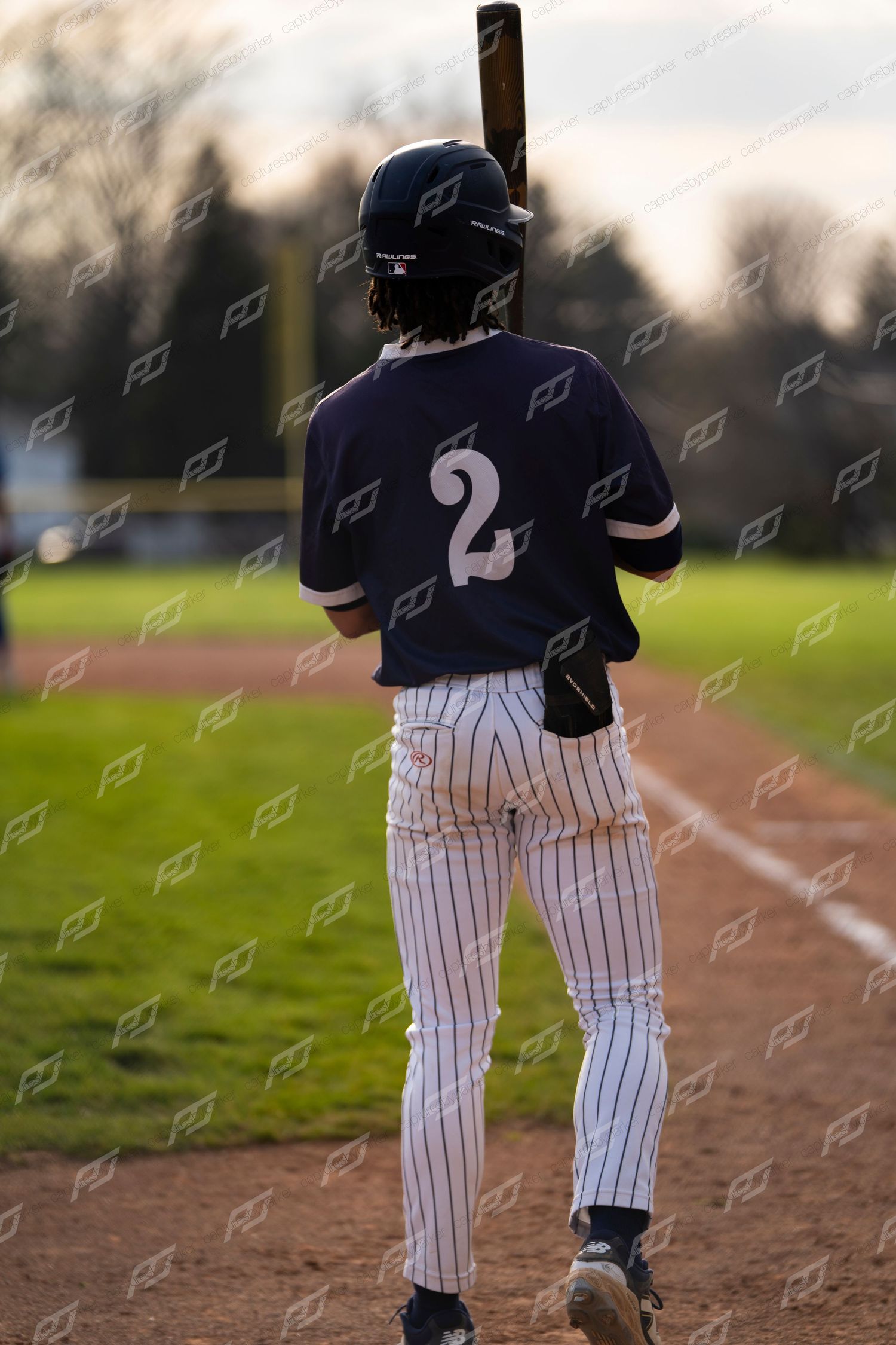 Baseball batter #2 stands ready at the plate holding a bat during a game.