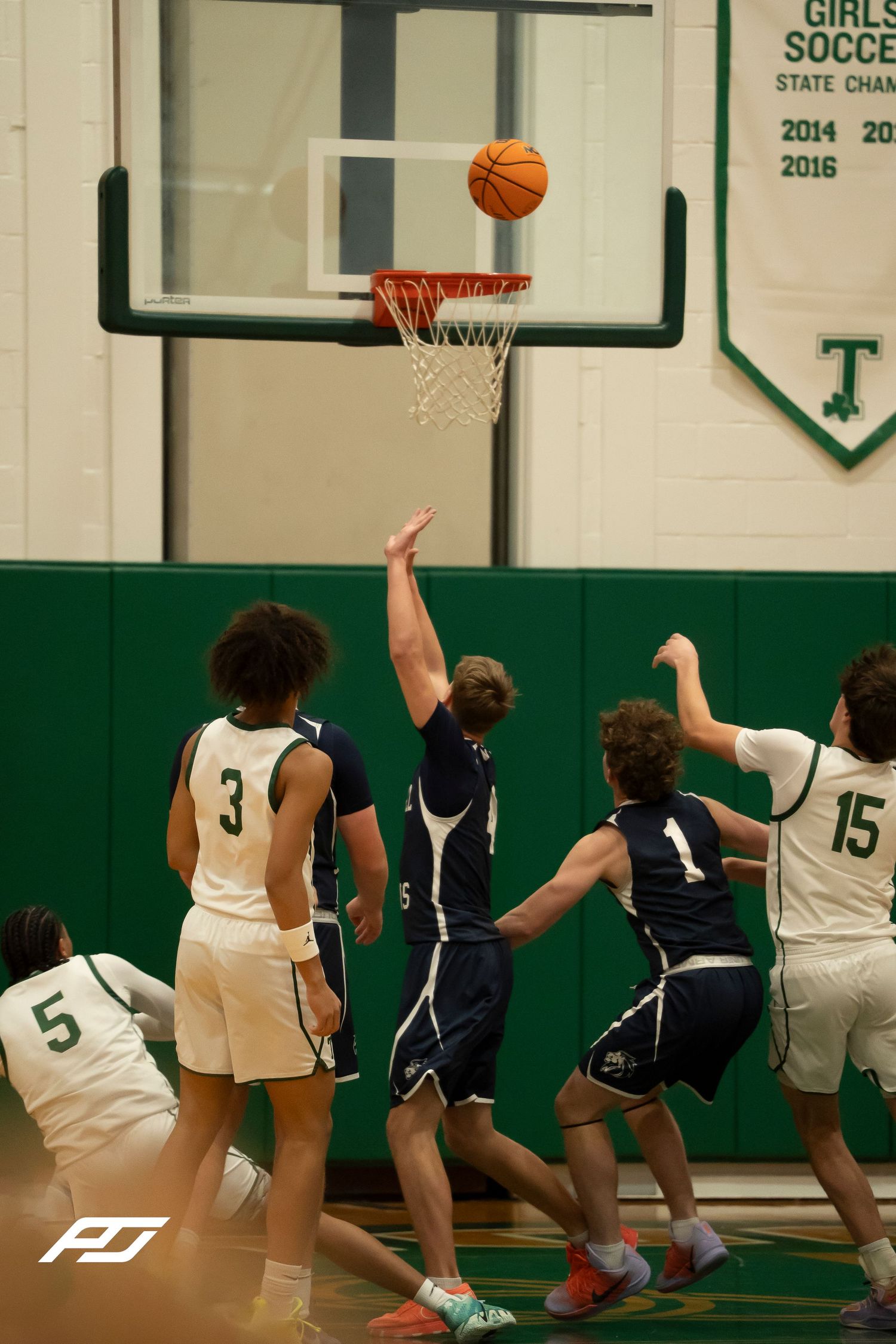 Camp Hill Lions basketball player attempts a layup during a high school game against Trinity.