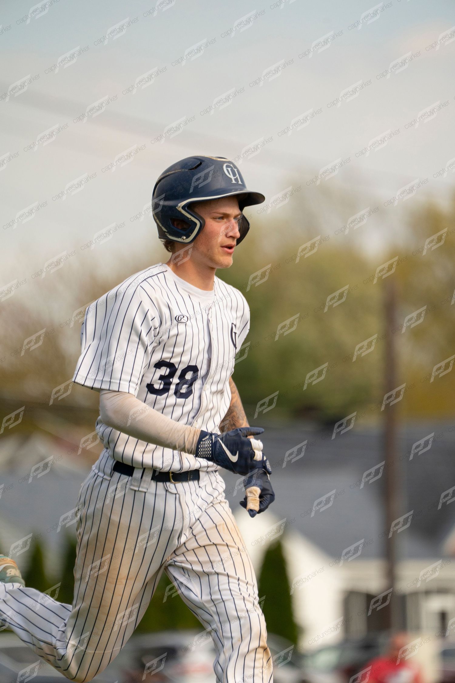 Baseball player number 38 in white pinstripe uniform runs the bases during a game.