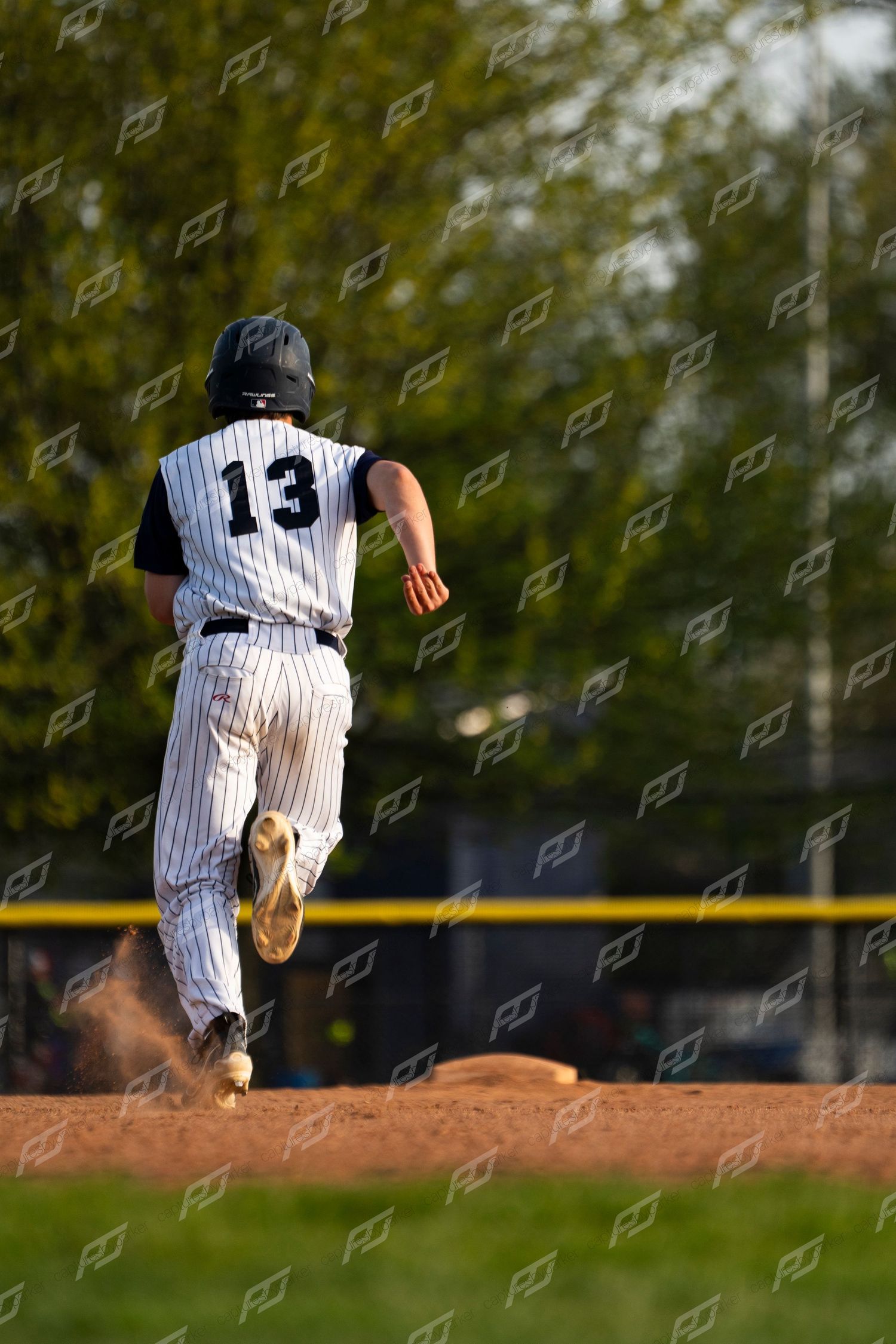Camp Hill baseball player number 13 runs the bases during a game.