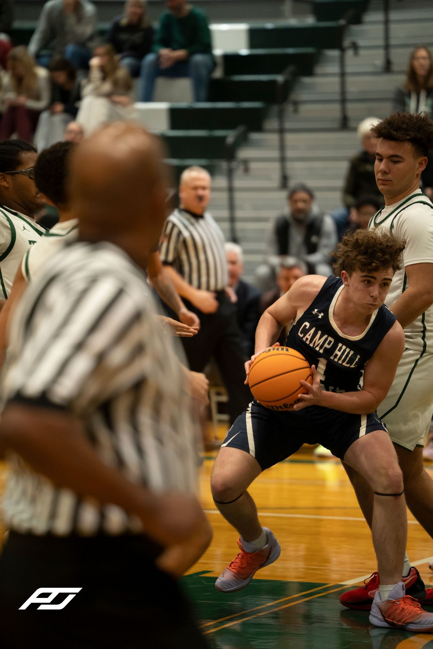 Camp Hill Lions player drives to the basket during a high school basketball game against Trinity.