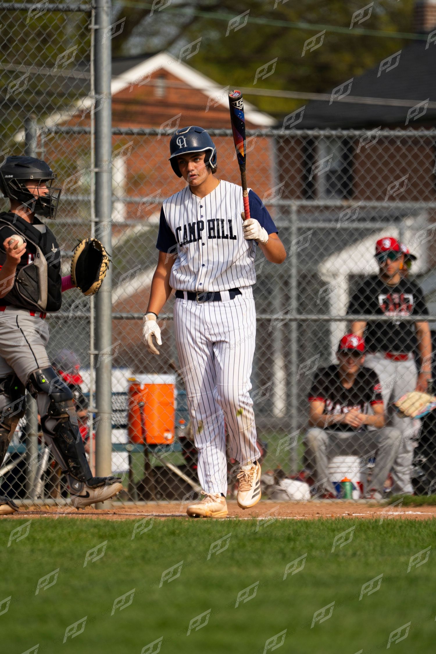 Camp Hill batter stands at home plate holding a bat while awaiting a pitch.
