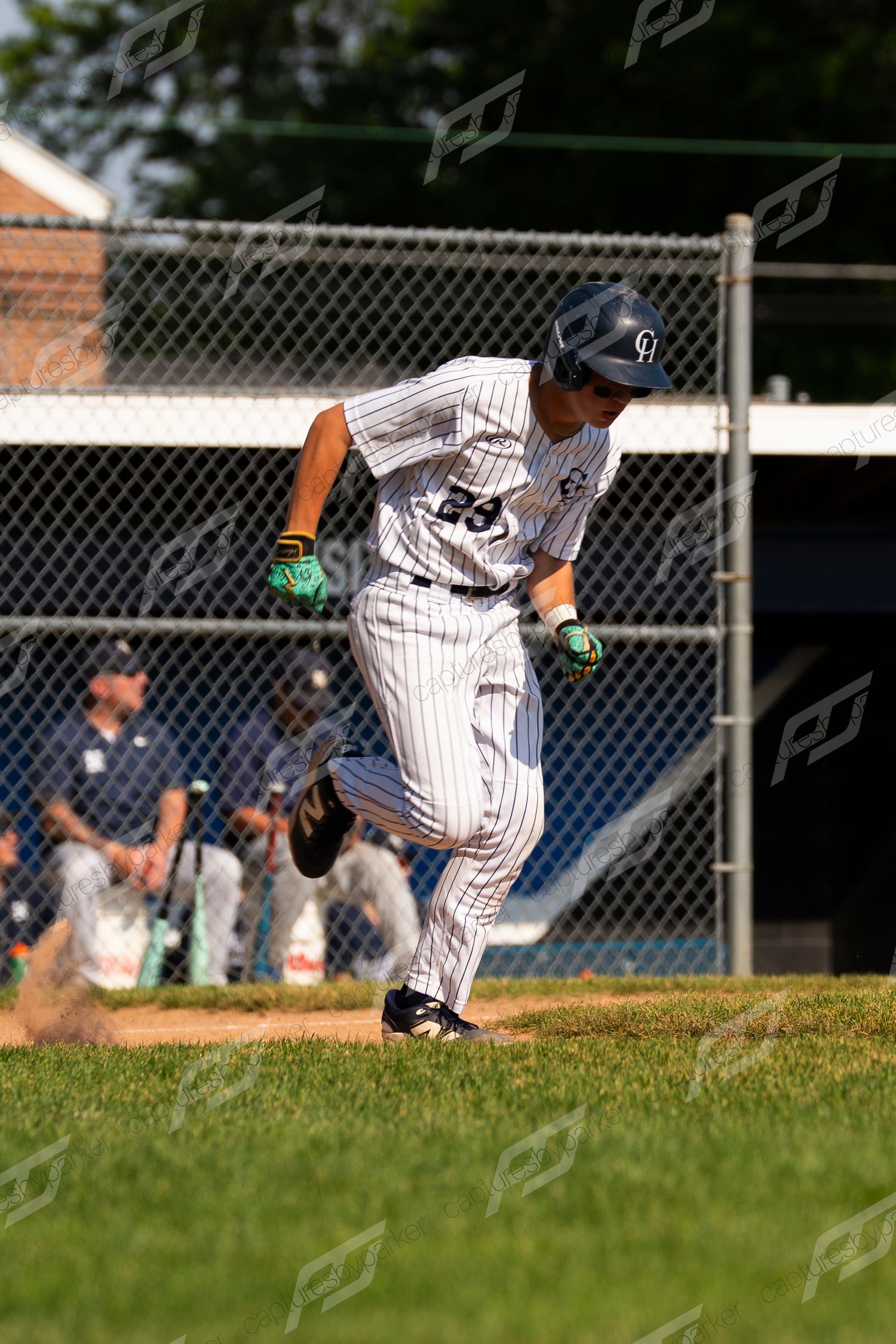 Baseball player #29 in pinstripe uniform sprints from home plate after making contact during a game.