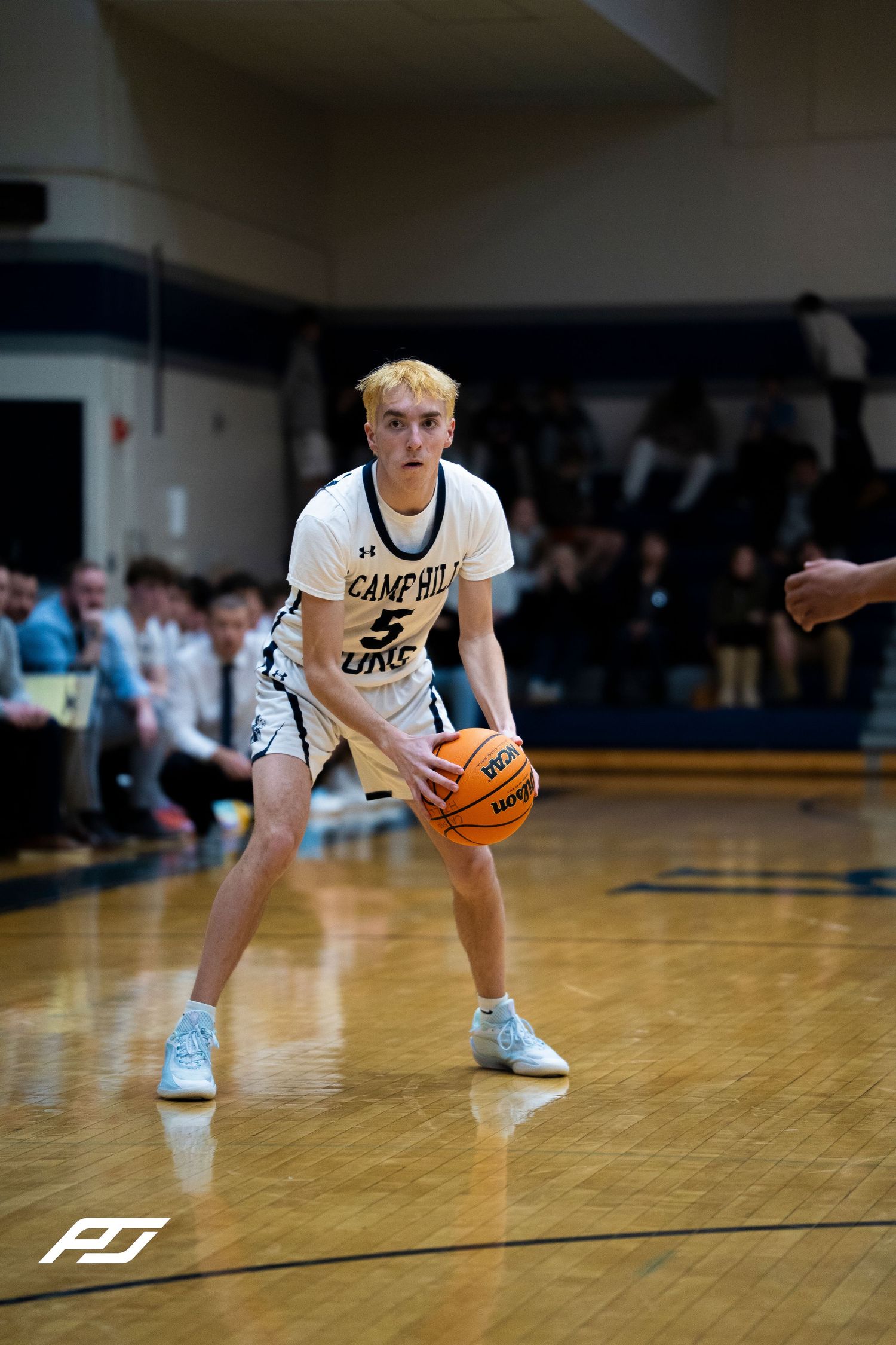 Camp Hill Lions #5 handles ball at perimeter during home basketball game against Trinity High School.