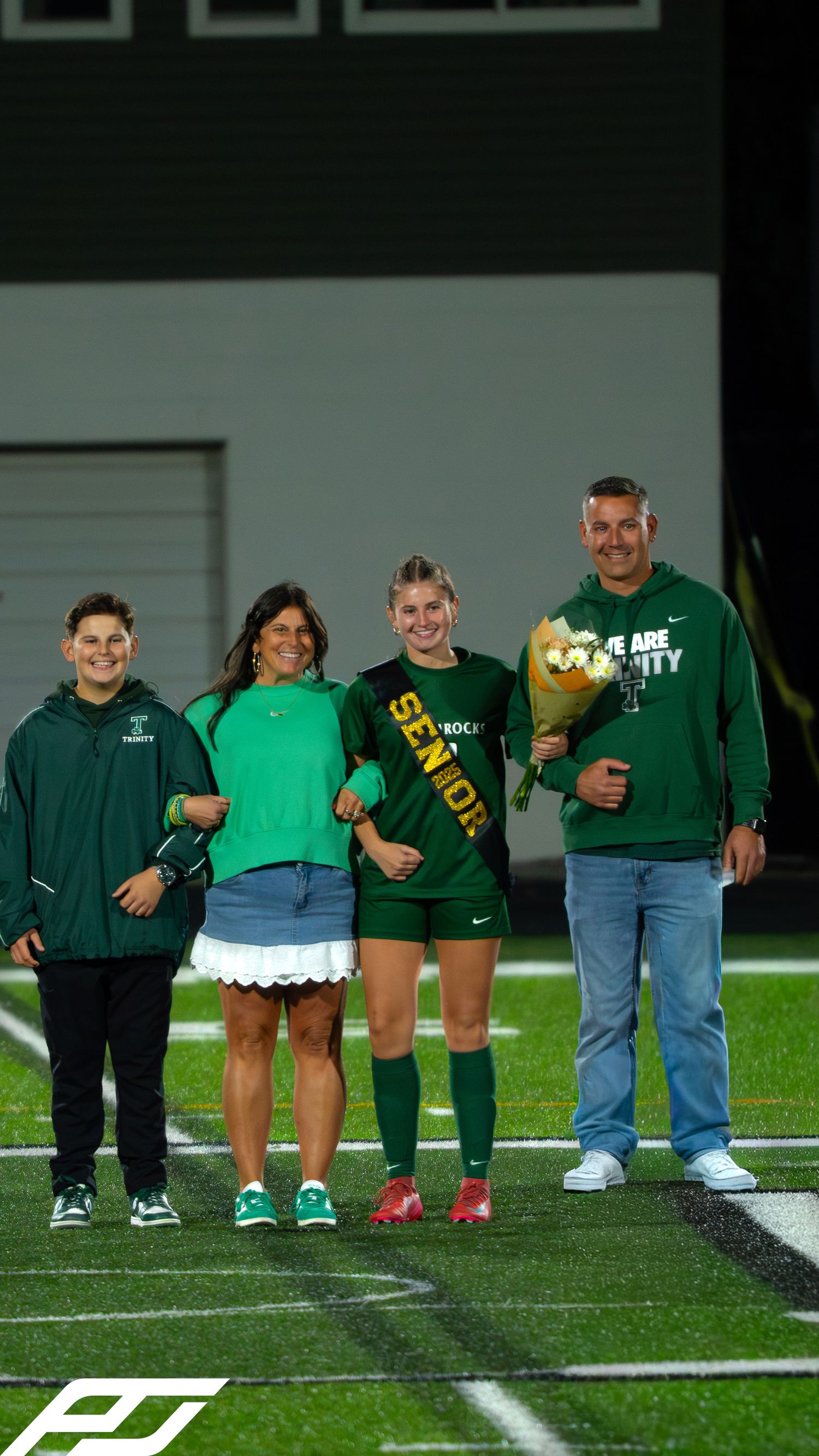 Trinity Shamrocks senior soccer player celebrates senior night with family wearing green and gold apparel.