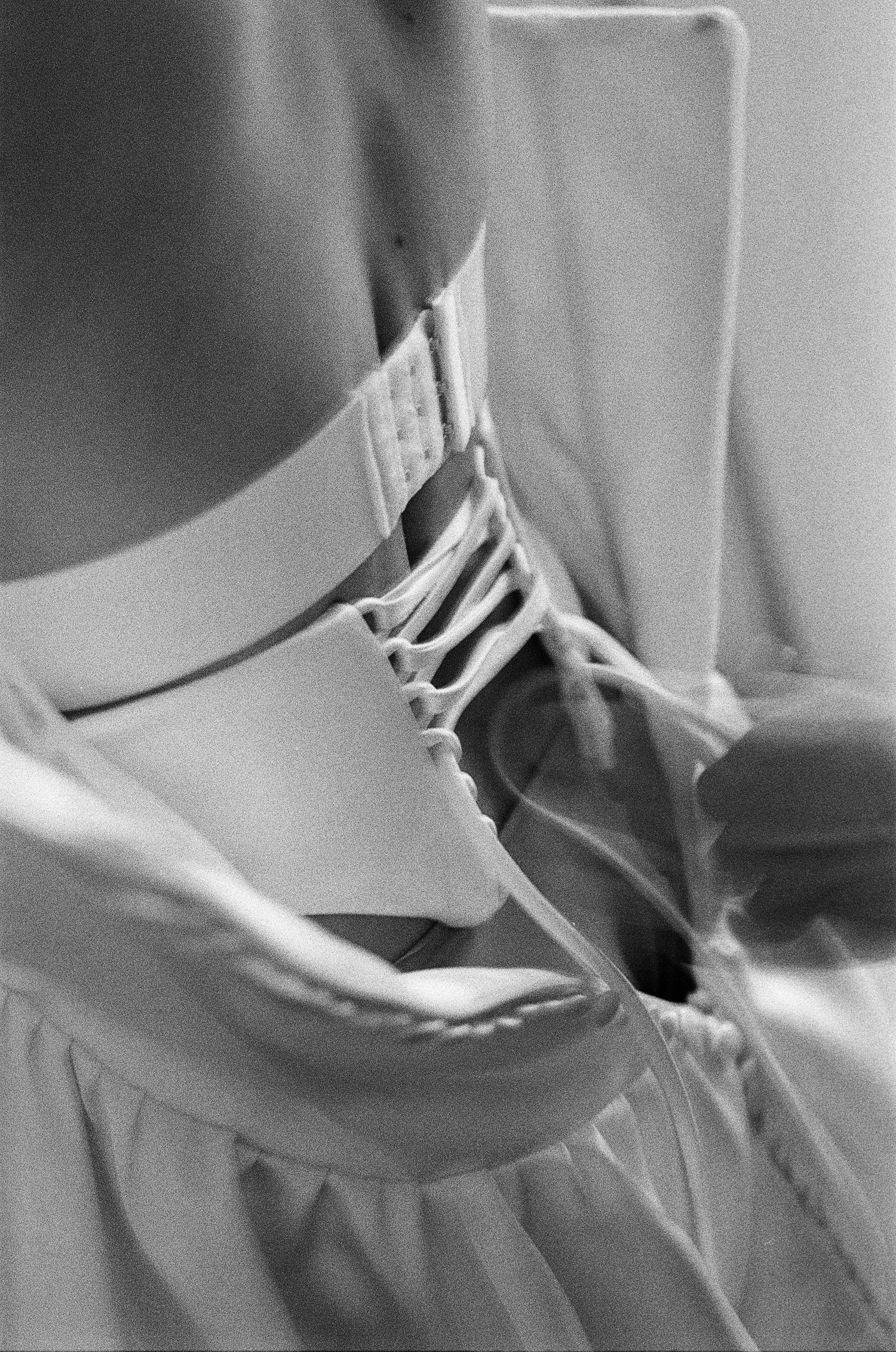 Close-up black and white images of dress details and fabric textures.