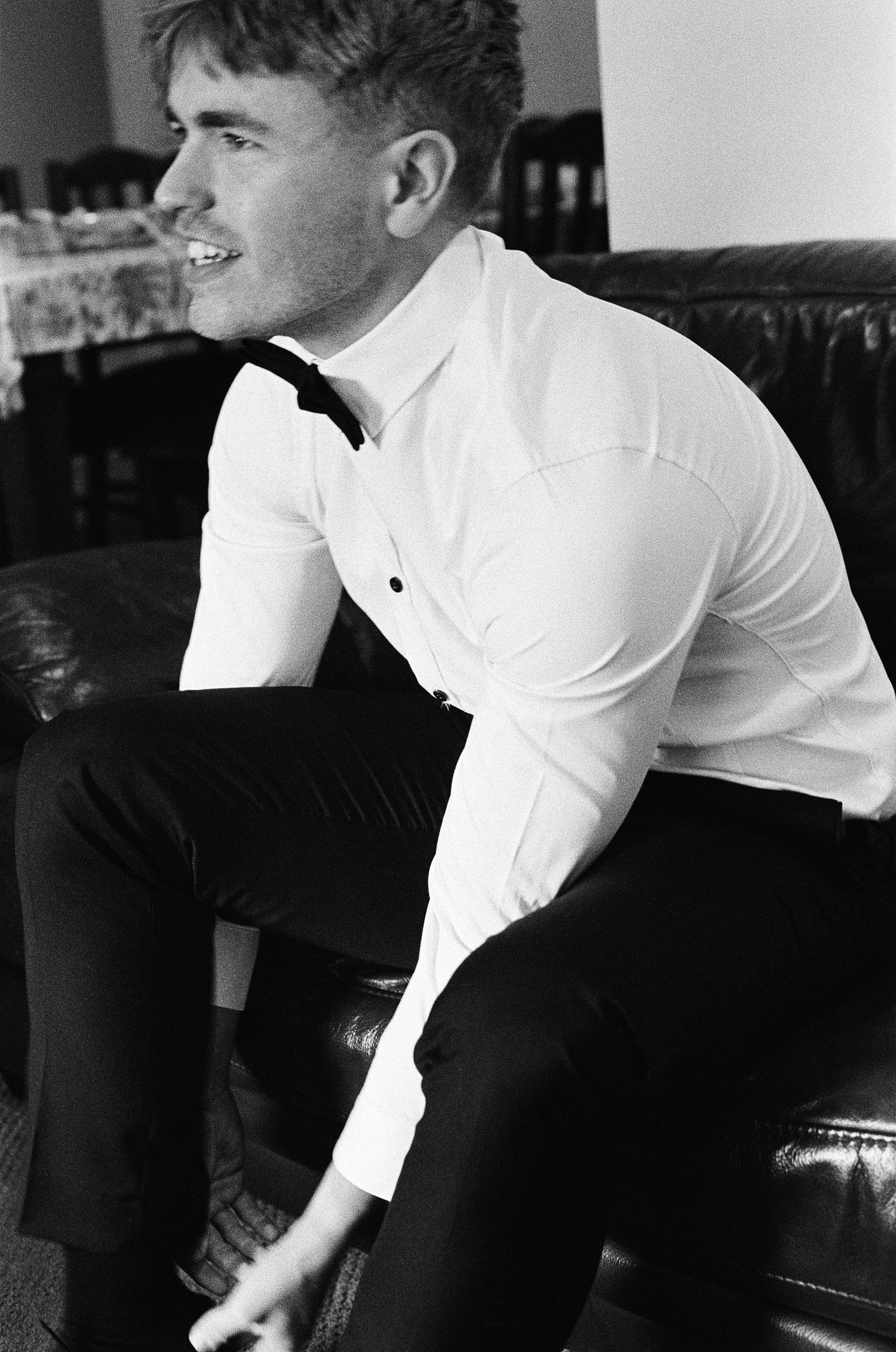 A black and white photograph showing formal attire and elegant styling.