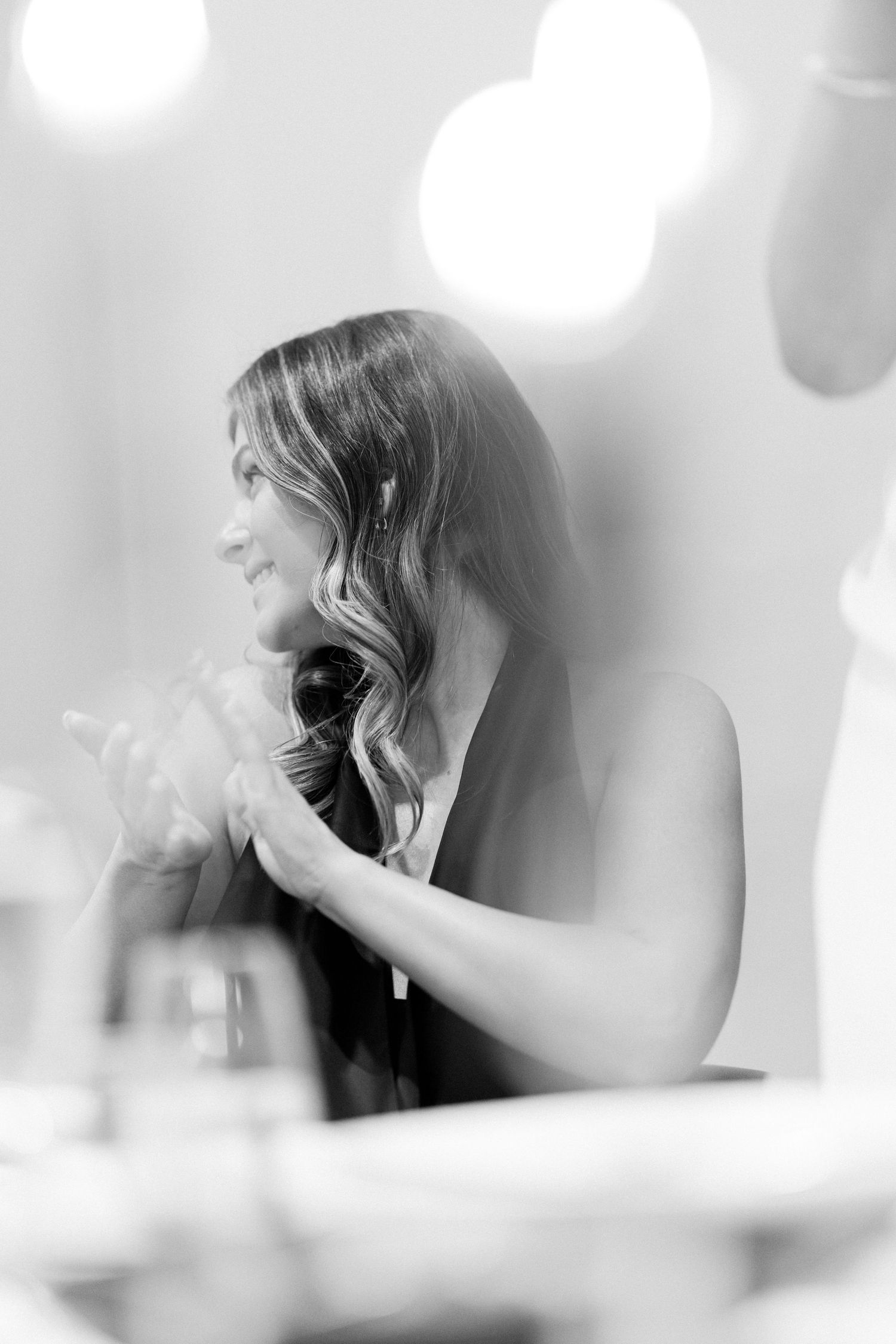 A dreamy, soft-focus black and white photo of someone at a wedding reception.