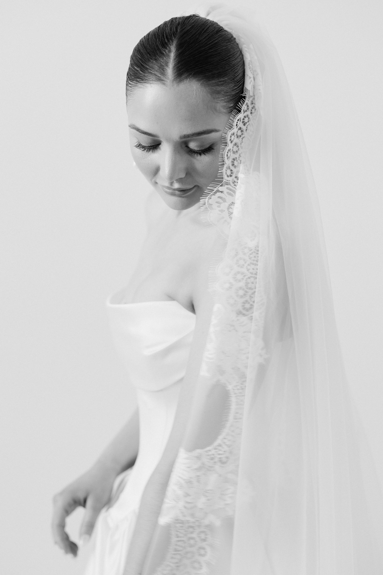 Classic bridal portrait in black and white with delicate lace veil.