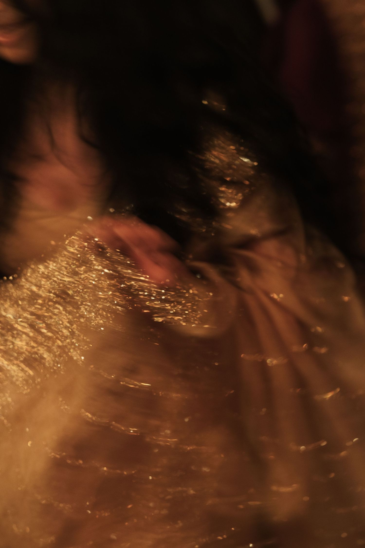 Abstract blurred golden light with motion blur effect creating a warm, ethereal bokeh artistic photograph.