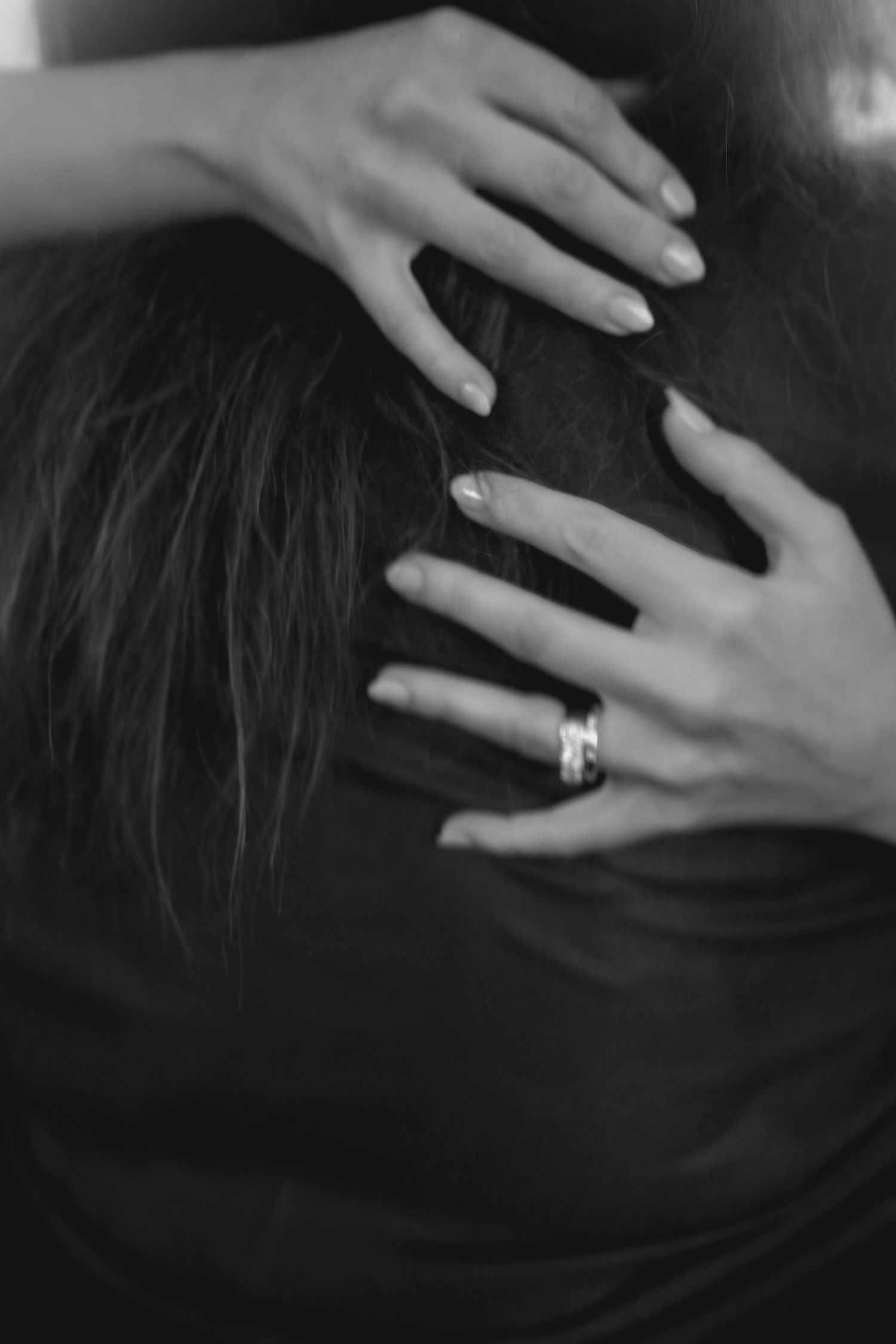 Close-up sequence of hands with engagement ring against dark background.