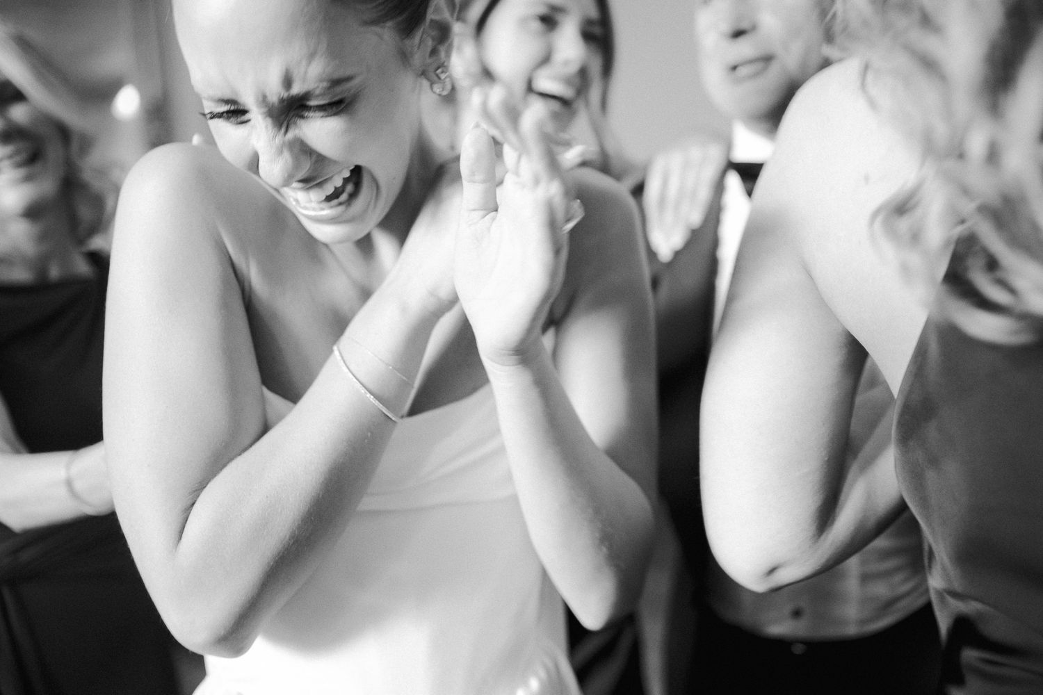 Series of black and white emotional expressions at a wedding celebration.