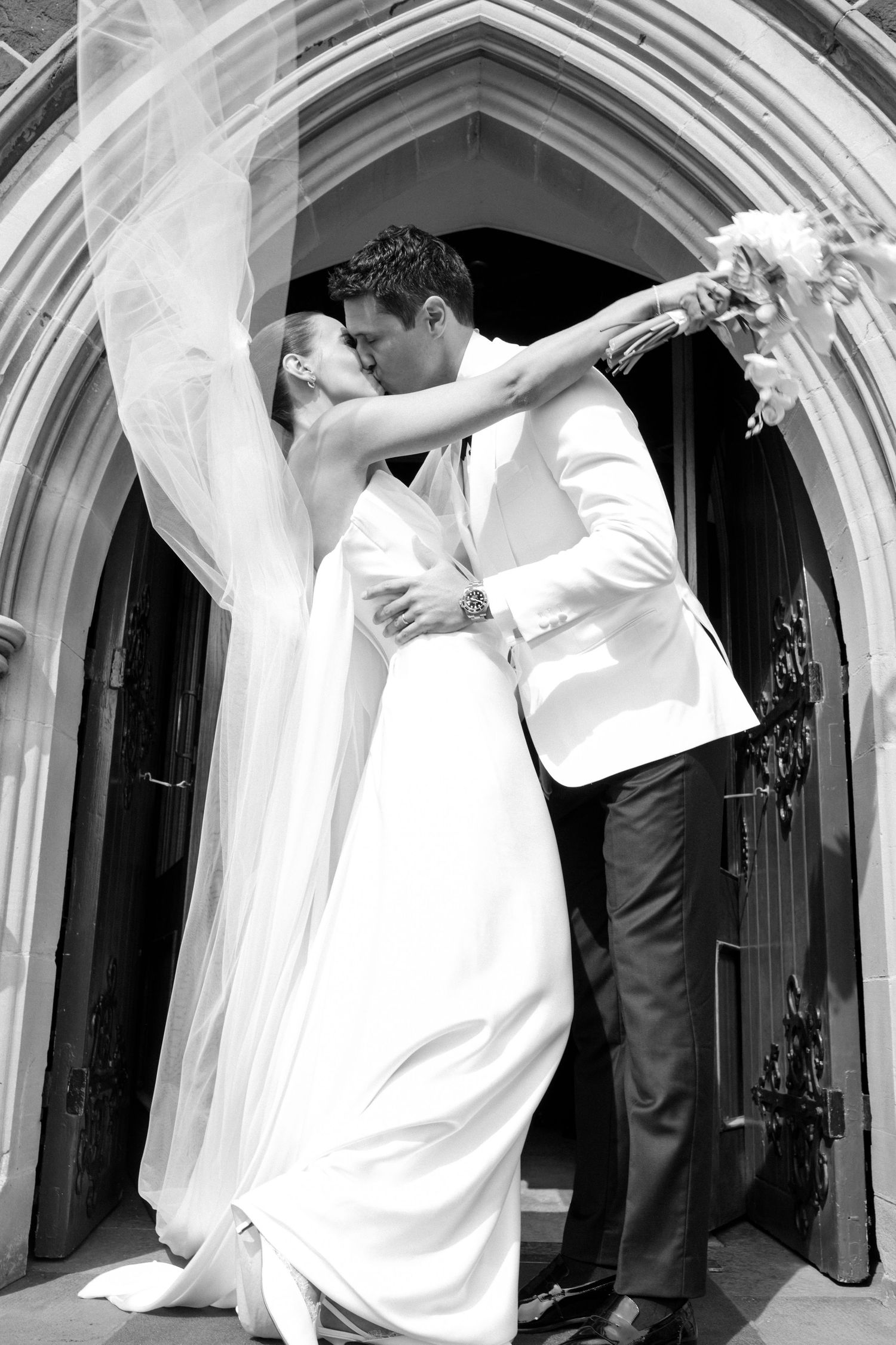 Black and white wedding photos show romantic dancing couples in elegant archways during a celebration.
