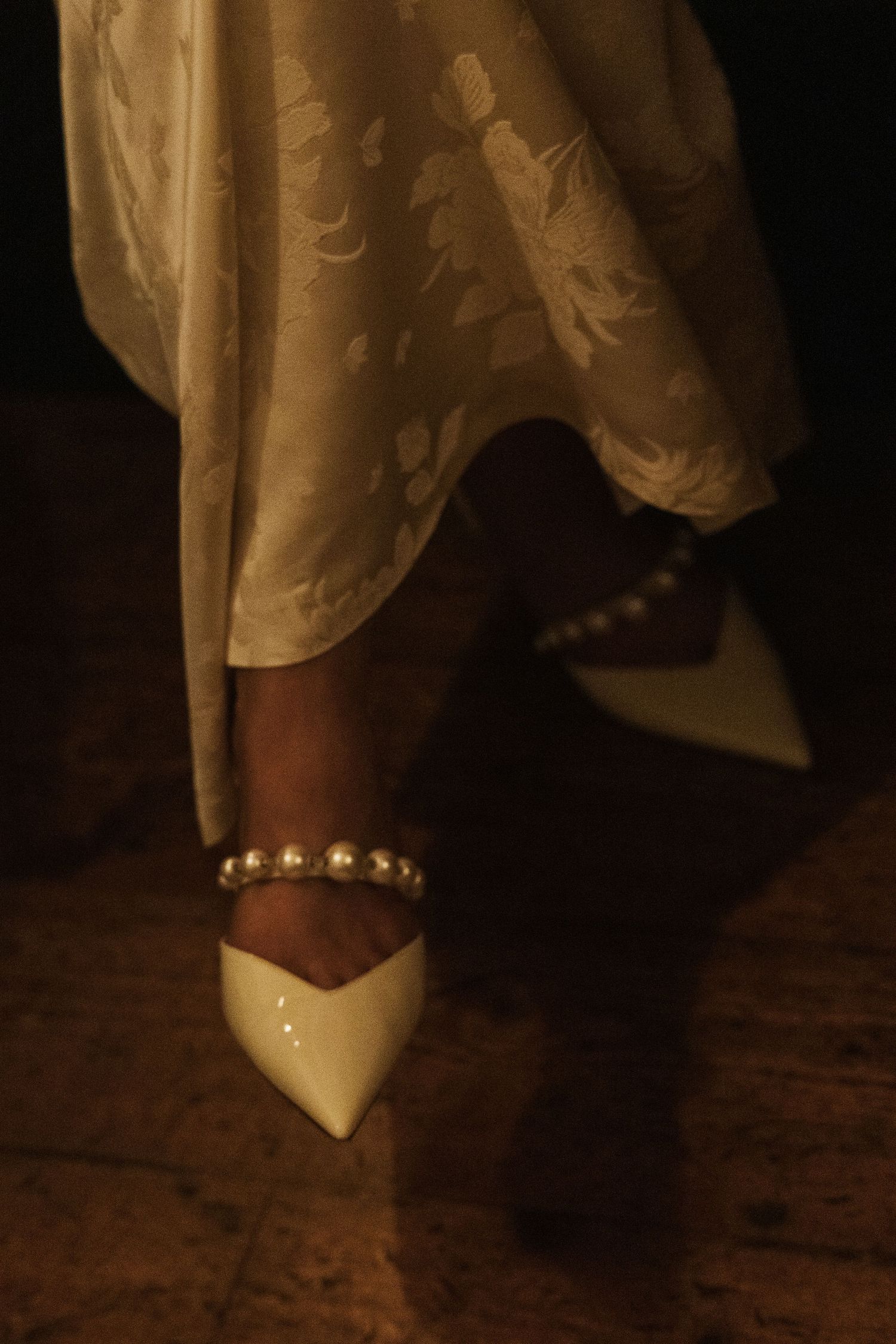 A sequence of close-up photos showing pearl-adorned white bridal shoes on a dark wooden floor.