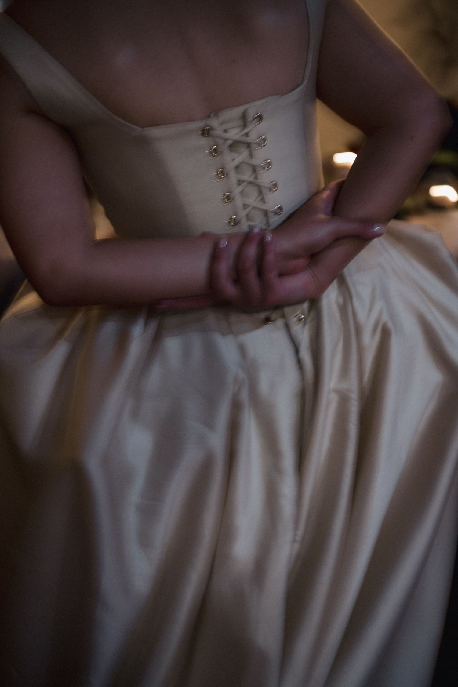 Close-up detail of white wedding dress fabric and embroidery.