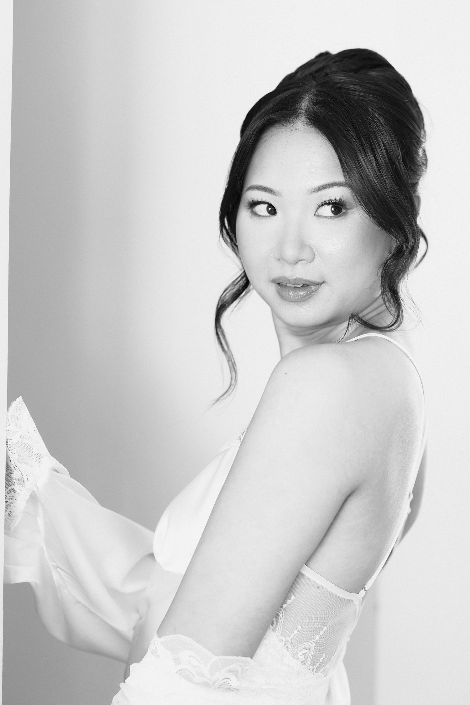 Artistic black and white boudoir portraits with soft lighting and elegant poses.