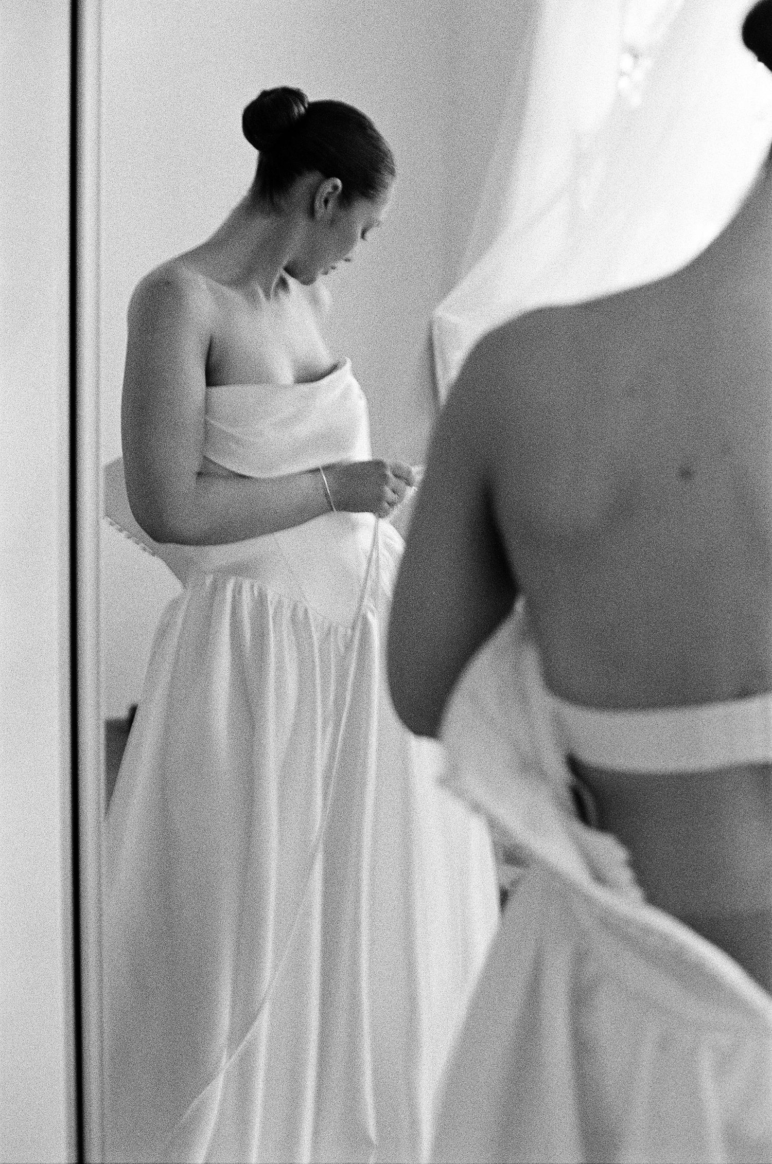 Artistic black and white photo series showing flowing white fabric against a light background.