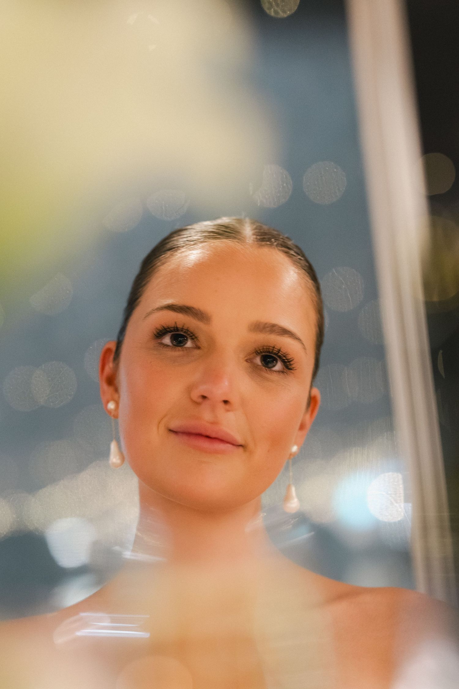 Close-up portrait showing soft lighting and elegant wedding makeup.