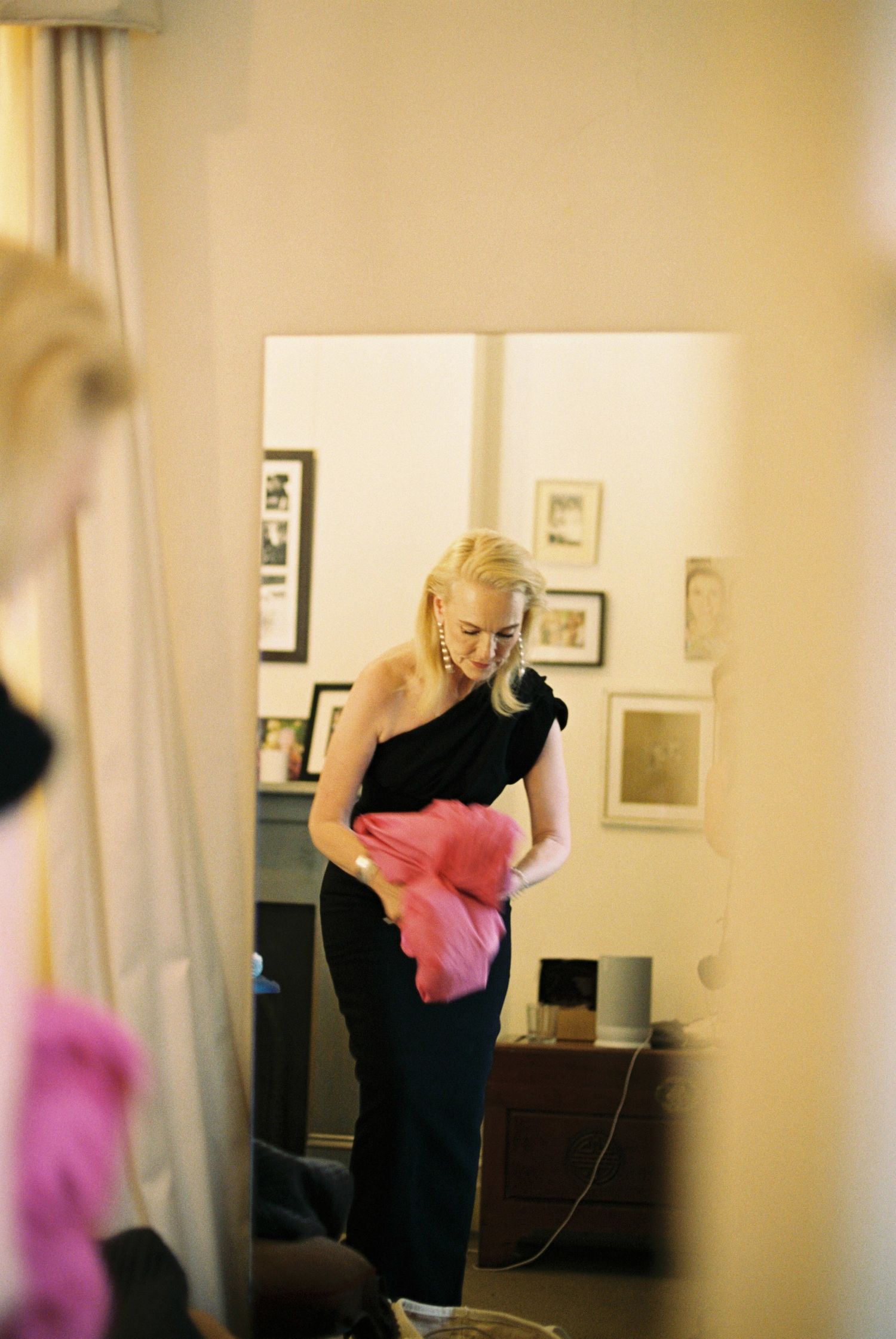 A blurry interior room scene with soft lighting and pink accents.