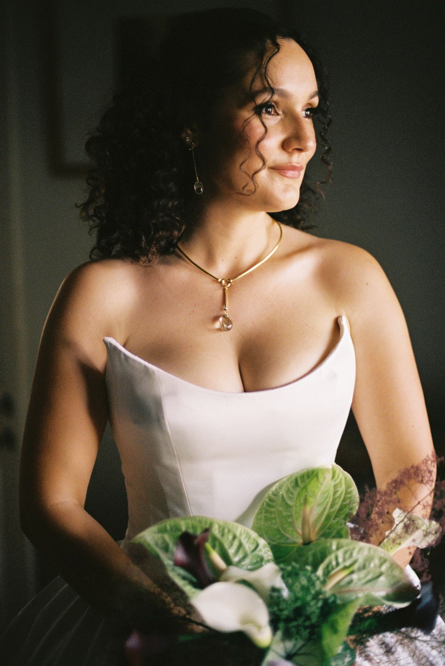 Elegant portrait with white dress and unique vegetable bouquet.