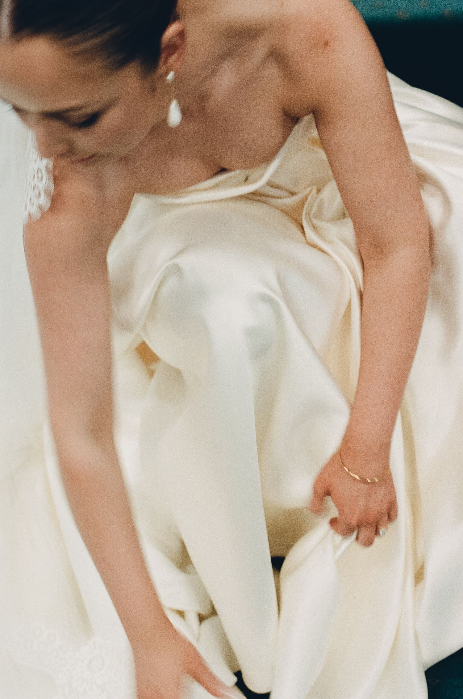 Close-up of a white wedding dress showing intricate fabric details.