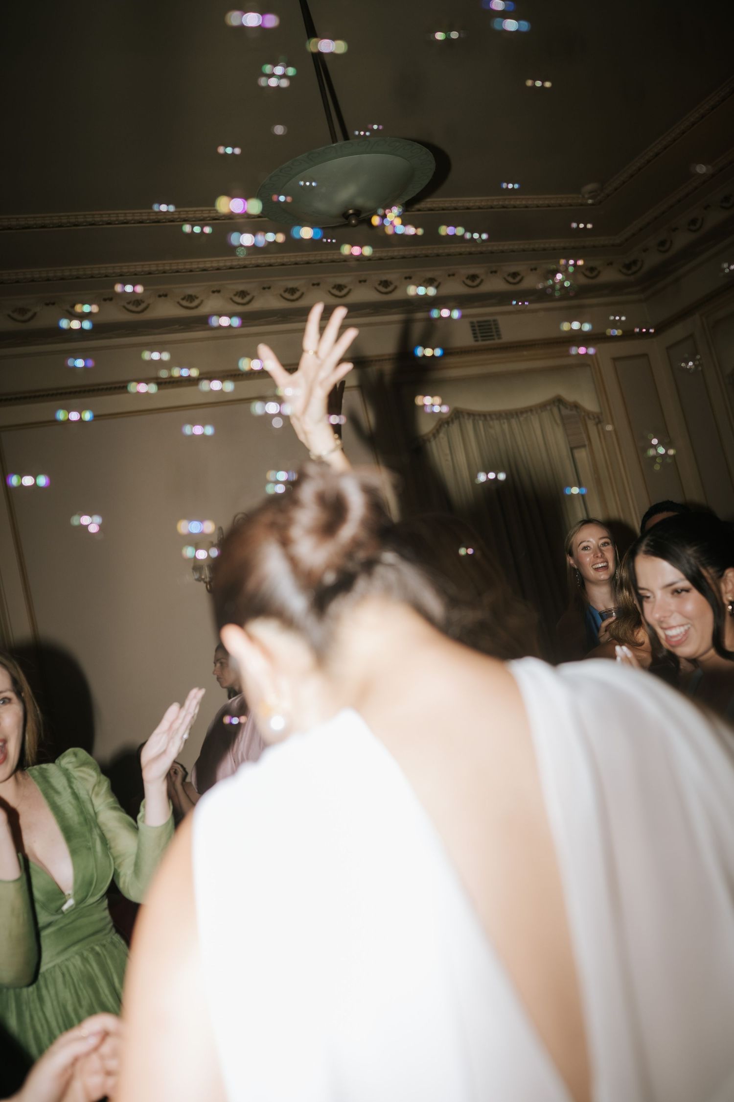 A blurry sequence of party photos showing people dancing and celebrating in a dimly lit indoor venue.