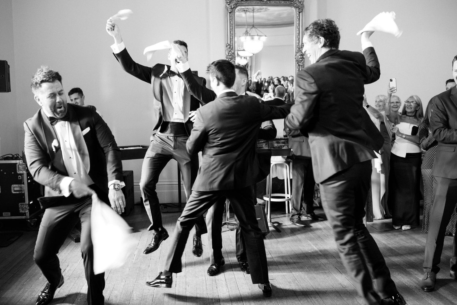 A sequence of black and white dance photos showing people practicing swing dance moves in a studio space.