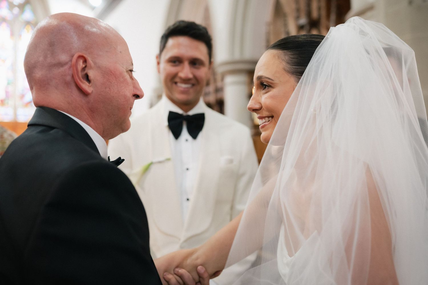 Wedding ceremony moments in traditional church setting.