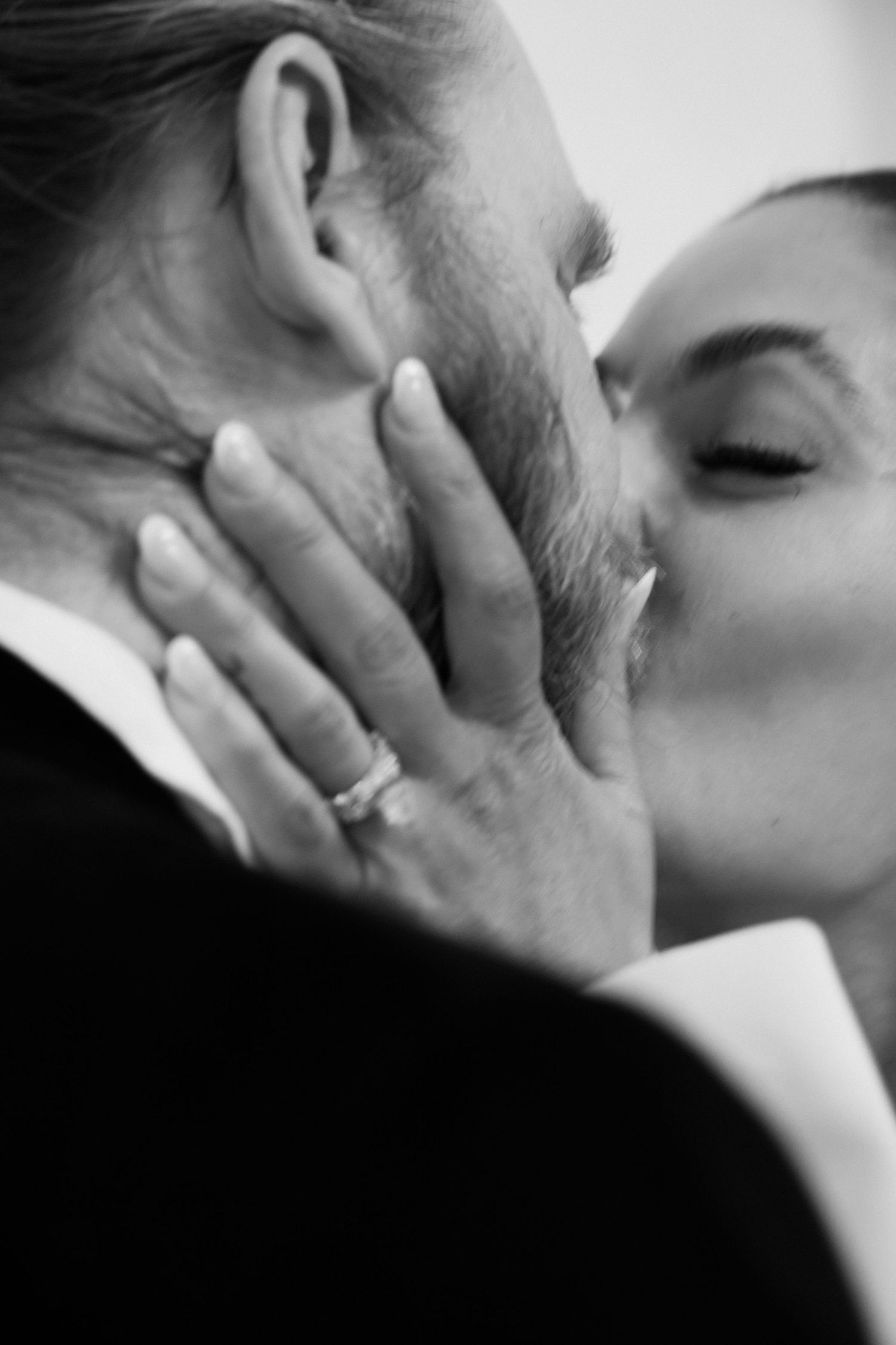 Intimate black and white close-up of a romantic kiss.
