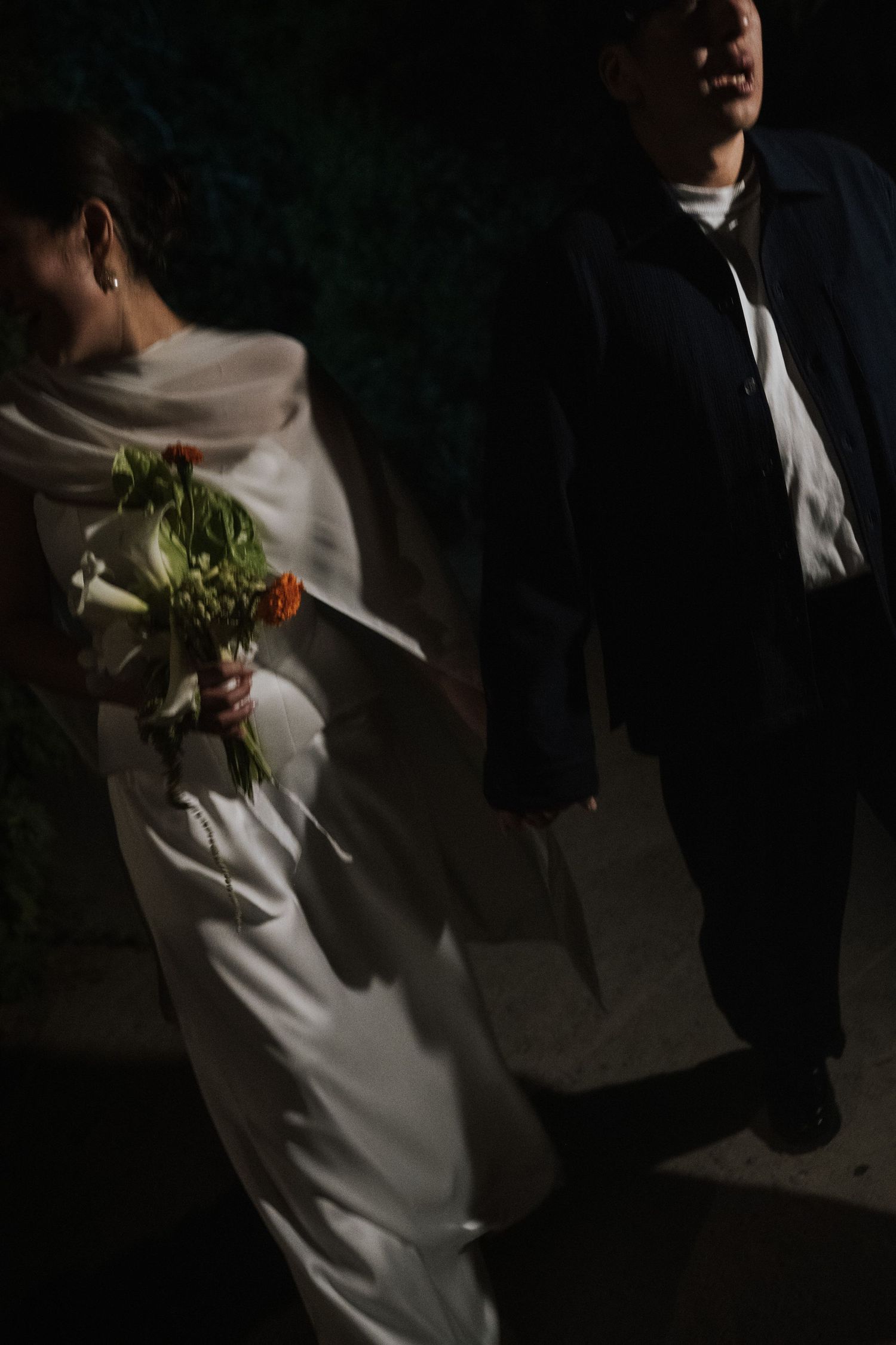 A sequence of dark wedding photos showing a couple dancing together in dramatic shadows and light.