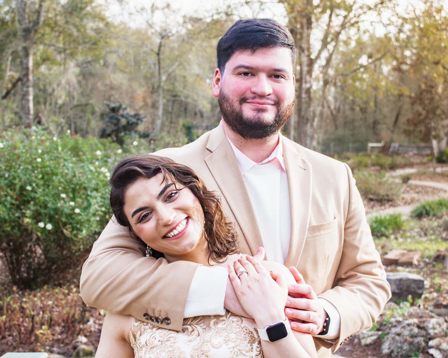 Romantic outdoor engagement photos in natural setting with beige and neutral tones.