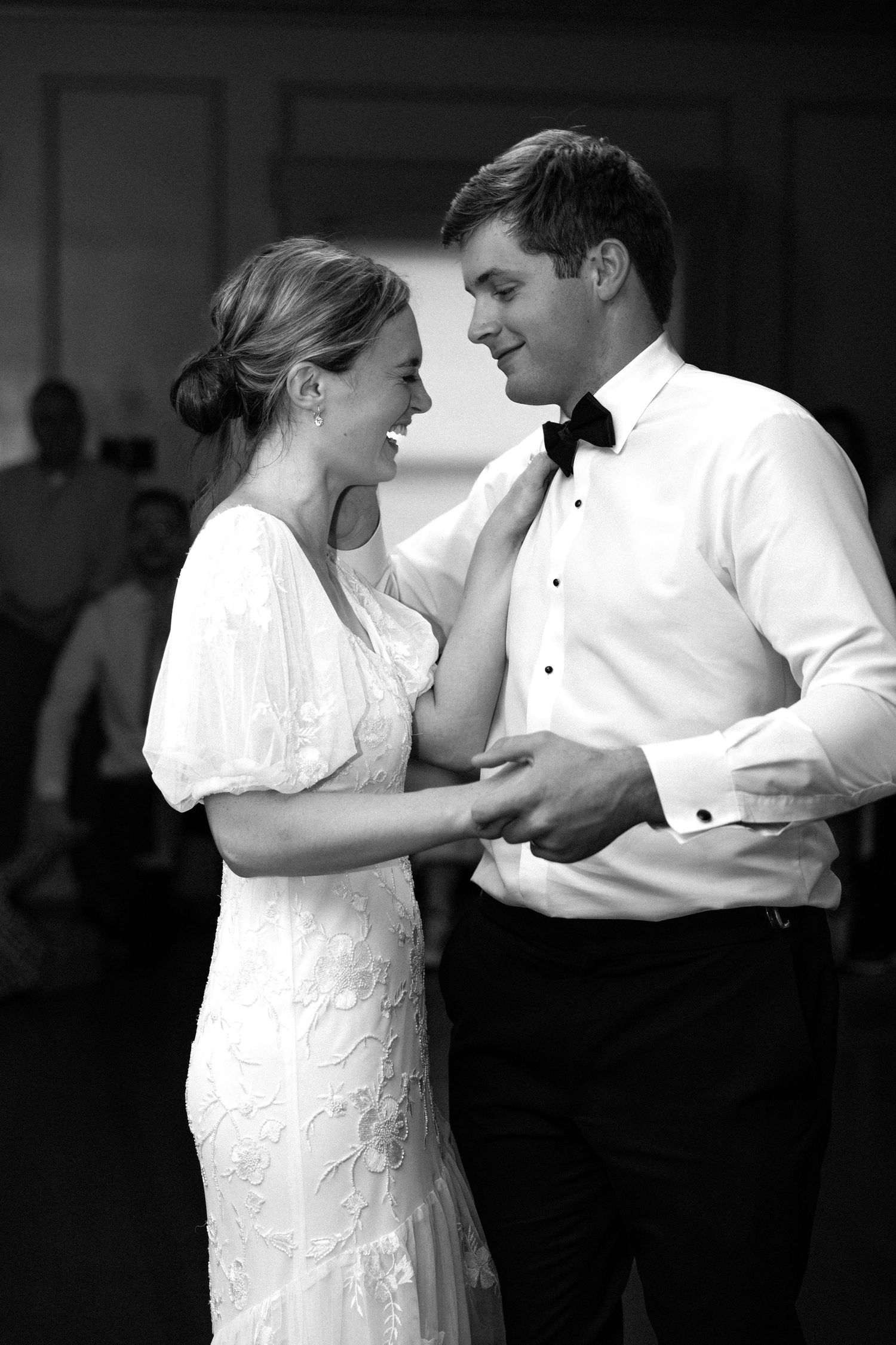 A romantic moment between newlyweds in formal attire during their wedding celebration.