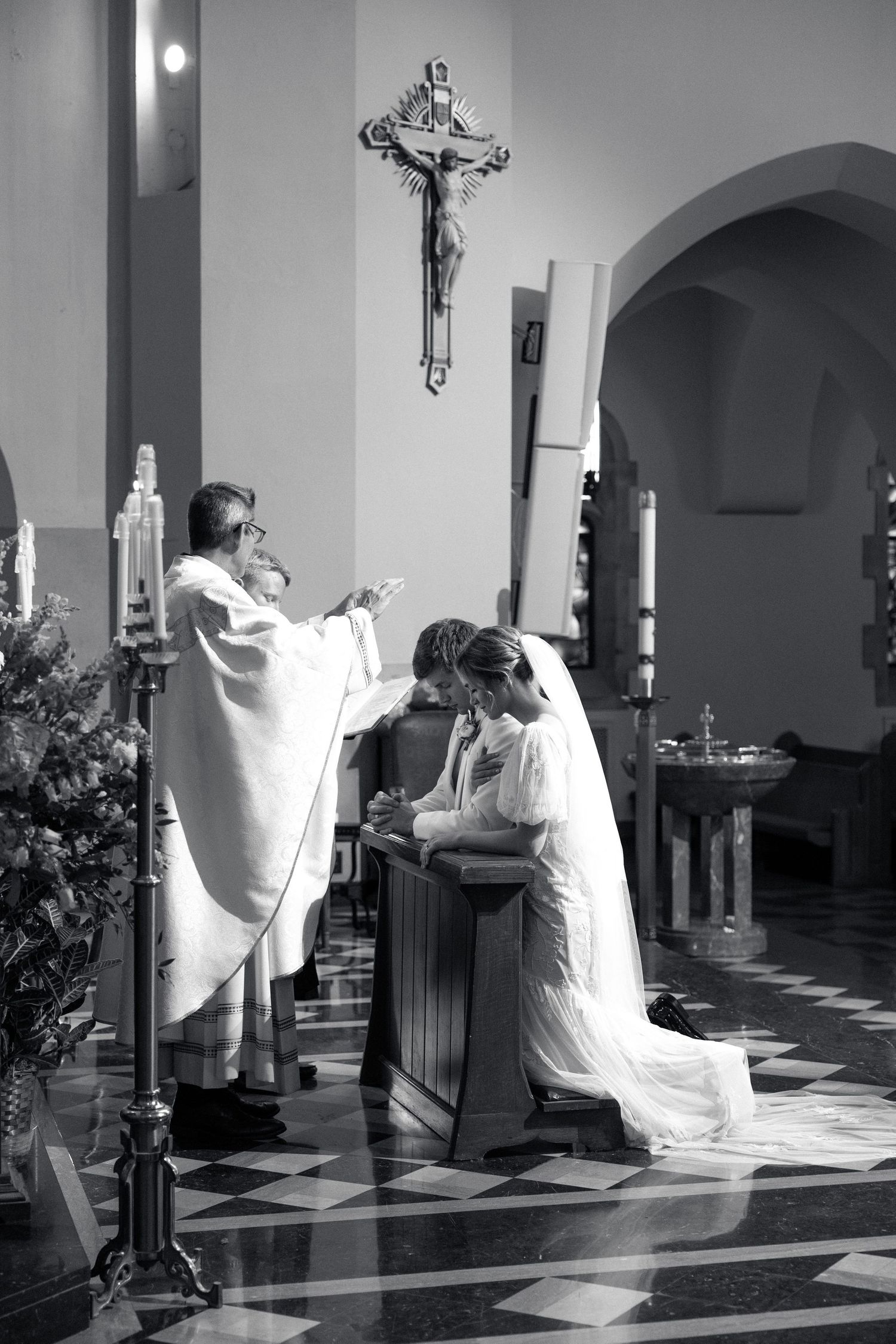 Artistic black and white sequence of dancers in flowing white dresses performing in a church.