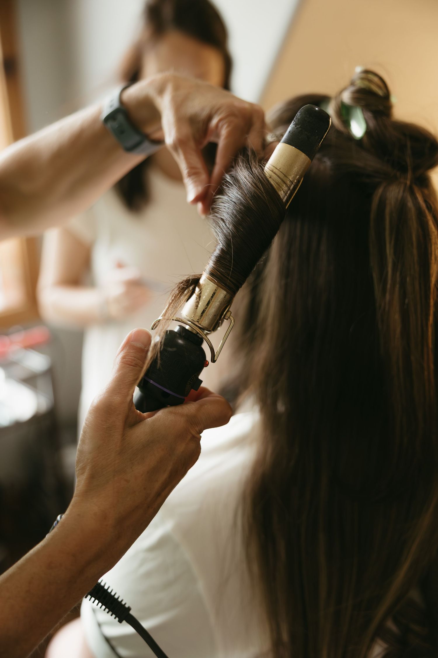 Hair styling preparation with professional tools and equipment before a special event.