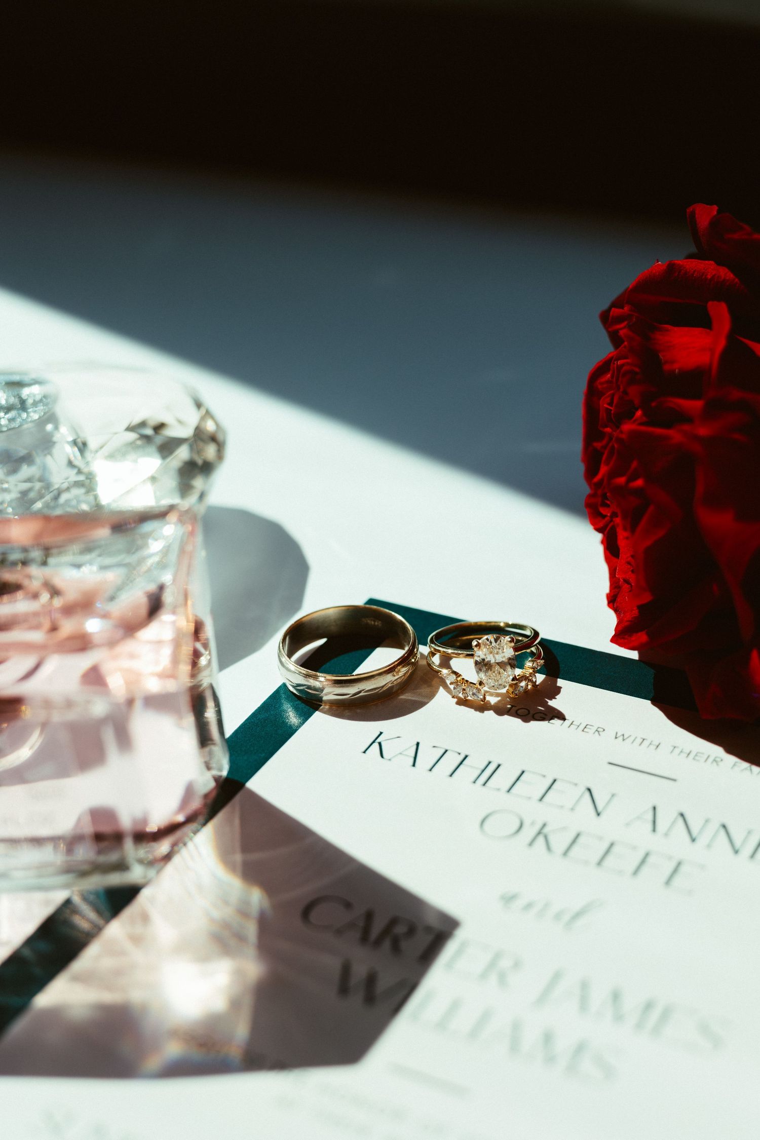 A series of wedding invitation cards with red roses and soft lighting create an elegant and romantic composition.