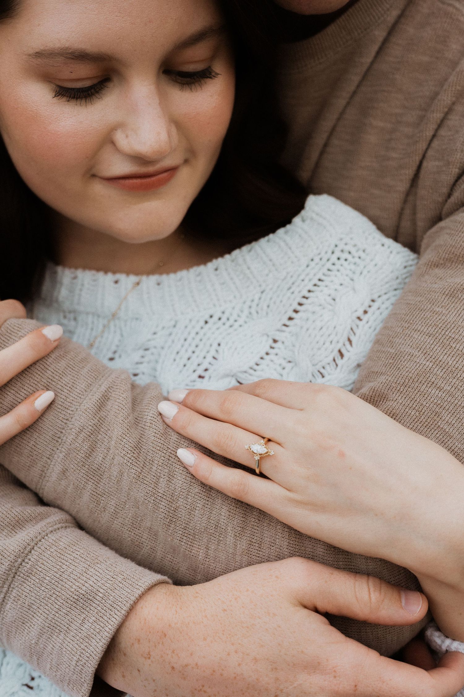 Close-up shots focusing on gentle embraces and a ring, capturing intimate moments between a couple.