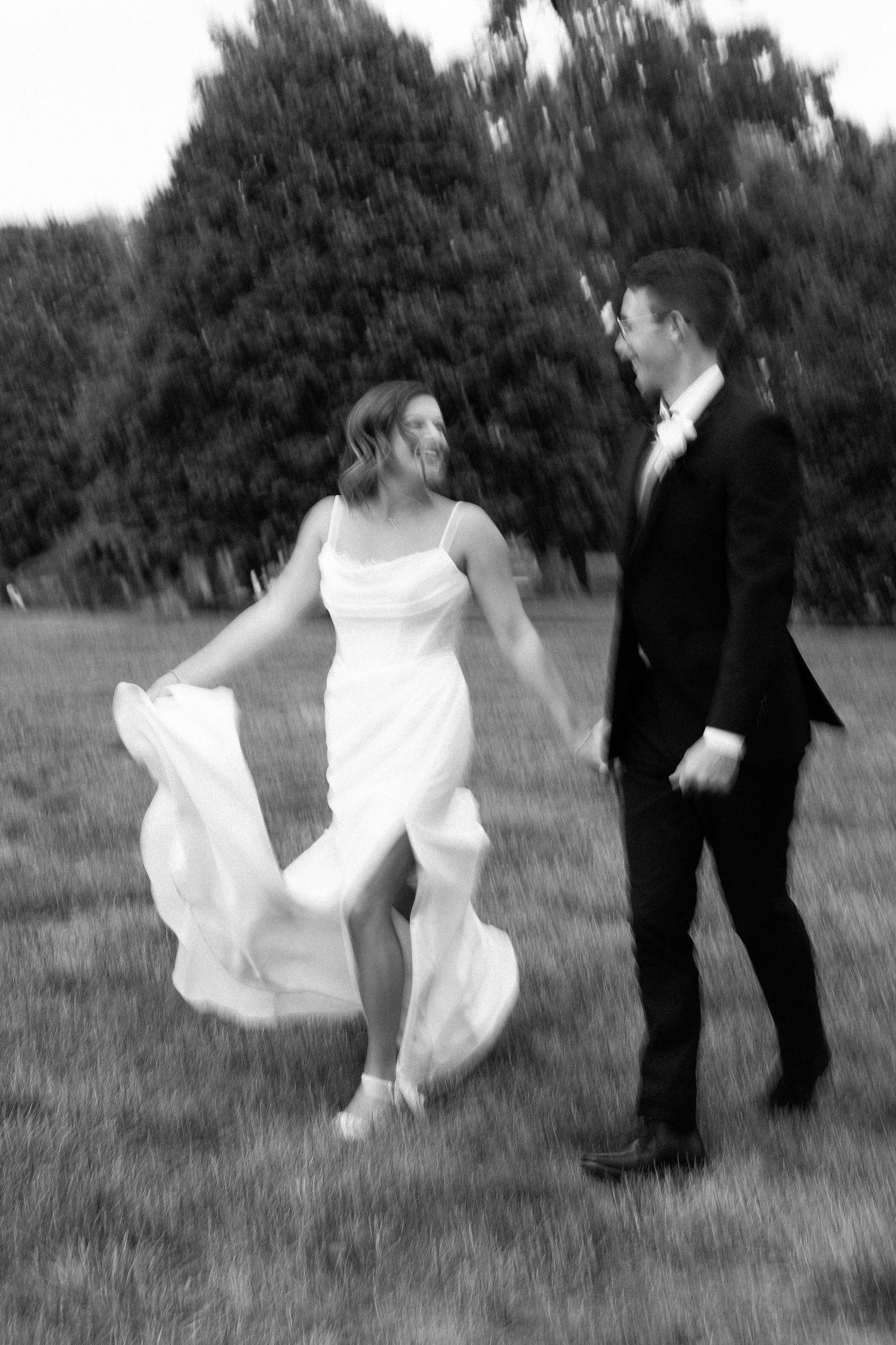 A black and white photo sequence shows a flowing white dress twirling against a dark suit in an outdoor field setting.