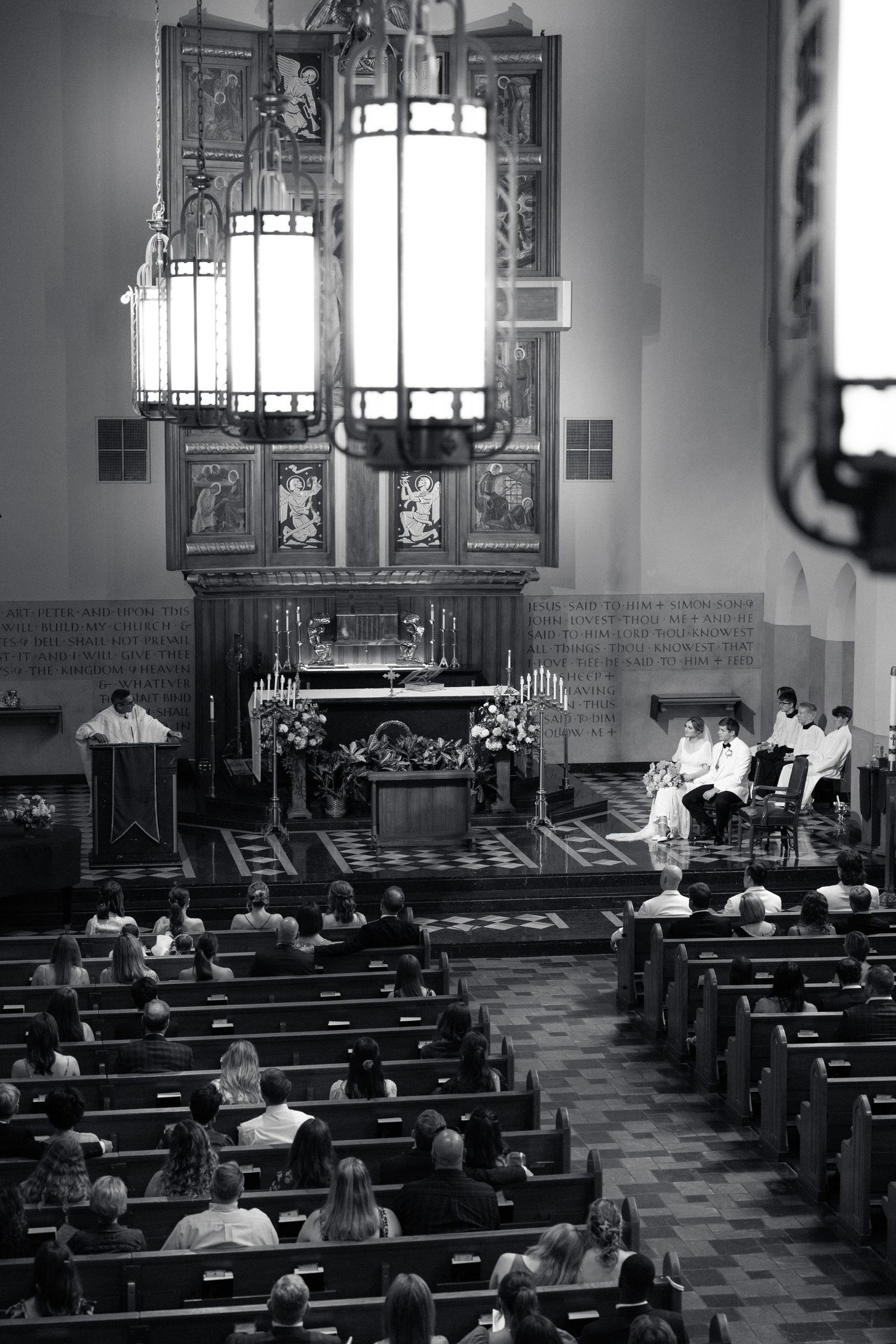 Black and white photograph of a church interior during a wedding service.