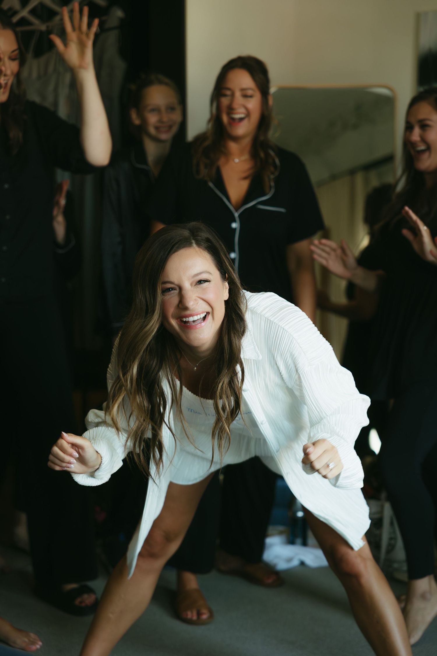 A sequence showing energetic dance moves at an indoor celebration with people in casual attire.